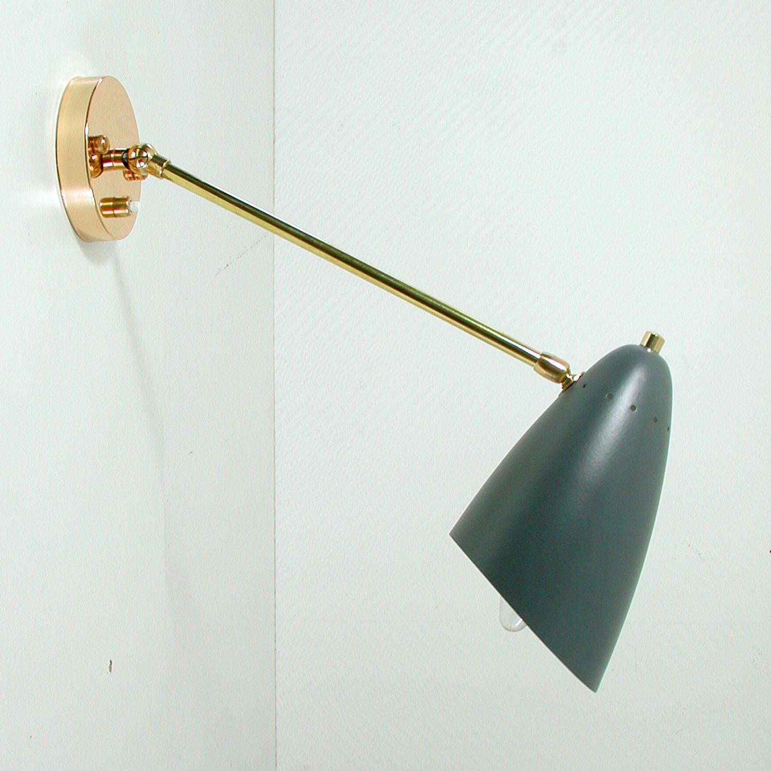 This elegant 1950s midcentury wall lamp / light fixture was designed and manufactured in Italy.

The wall light has got a dark grey lacquered shade, brass adjustable lamp arm and brass black plate (4 inches / 10 cm). The shade is also adjustable.