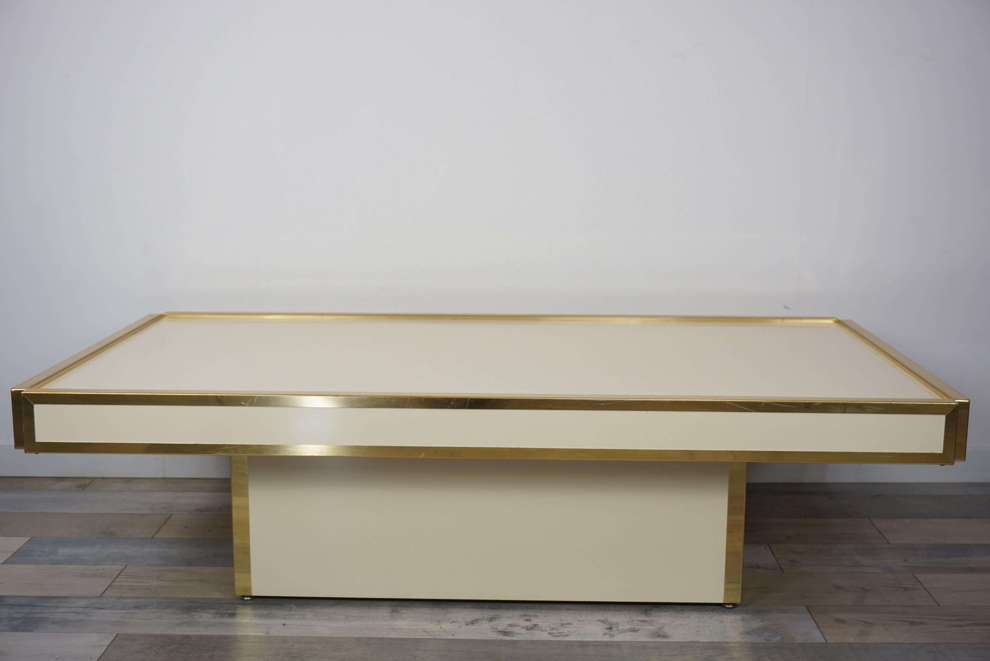 1960s-1970s Italian design coffee table with graphical and geometric lines, angles decorated with brass and ivory lacquer at the manner of Willy Rizzo and Aldo Tura. Rare!