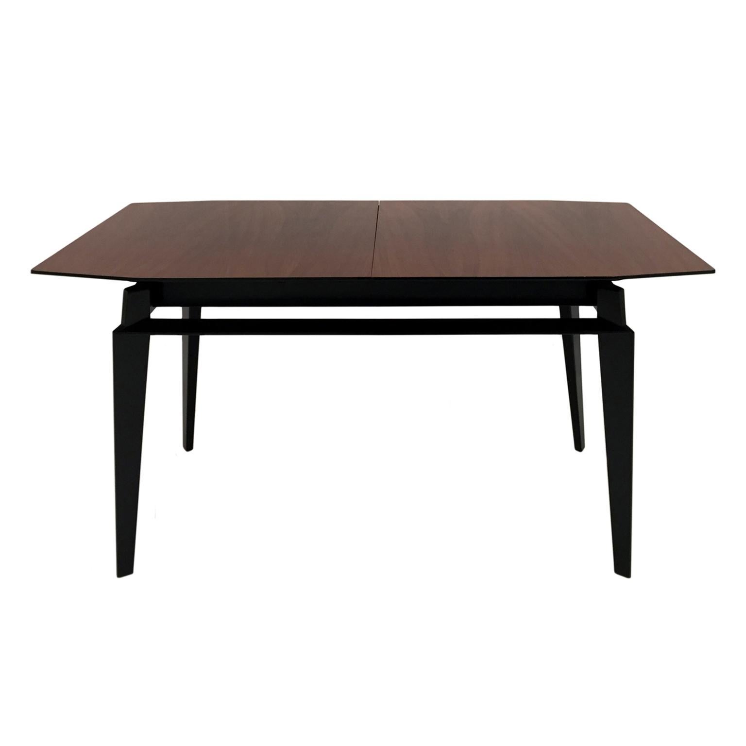 Midcentury extendable dining table by Vittorio Dassi featuring a rosewood veneer tabletop and tapered legs with stretchers. Includes one 12 inch leaf. Italy, 1950s.