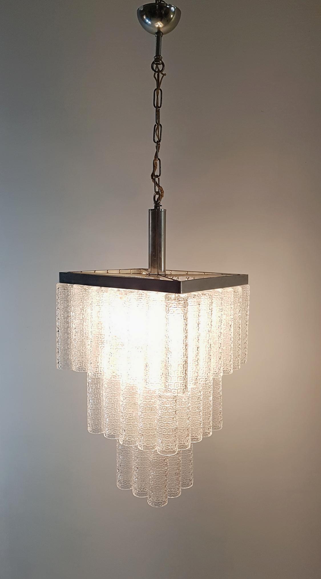 A square chandelier in three levels produced in Italy in the 1960s with glass tubes and in excellent condition. In total 6 light bulbs are used.
 