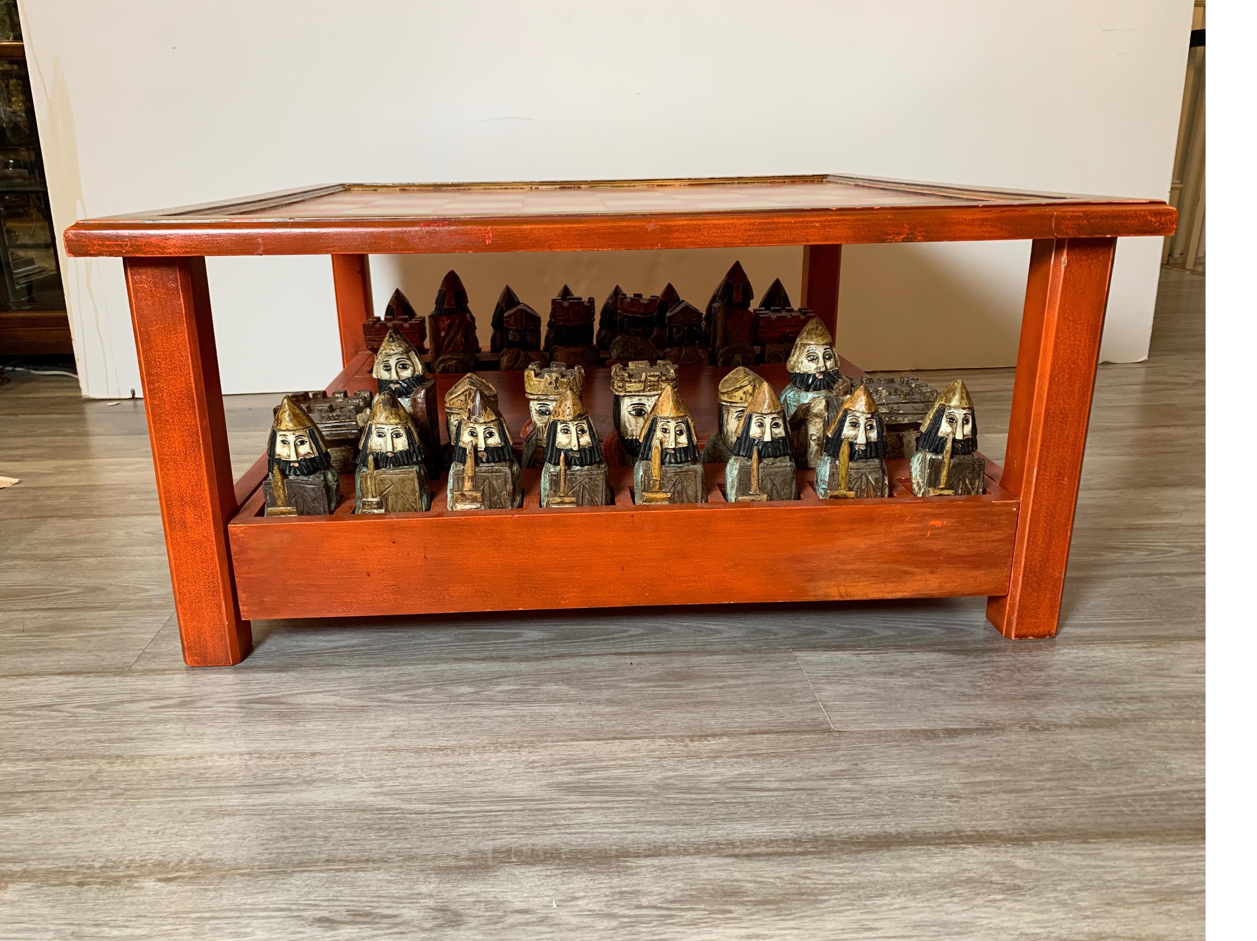 Midcentury Italian hand carved and painted medieval style chess set and table
removable glass top with fitted and slotted drawers for storage of figures.
Can also be used as cocktail/coffee table. Great addition to any game room
and conversation