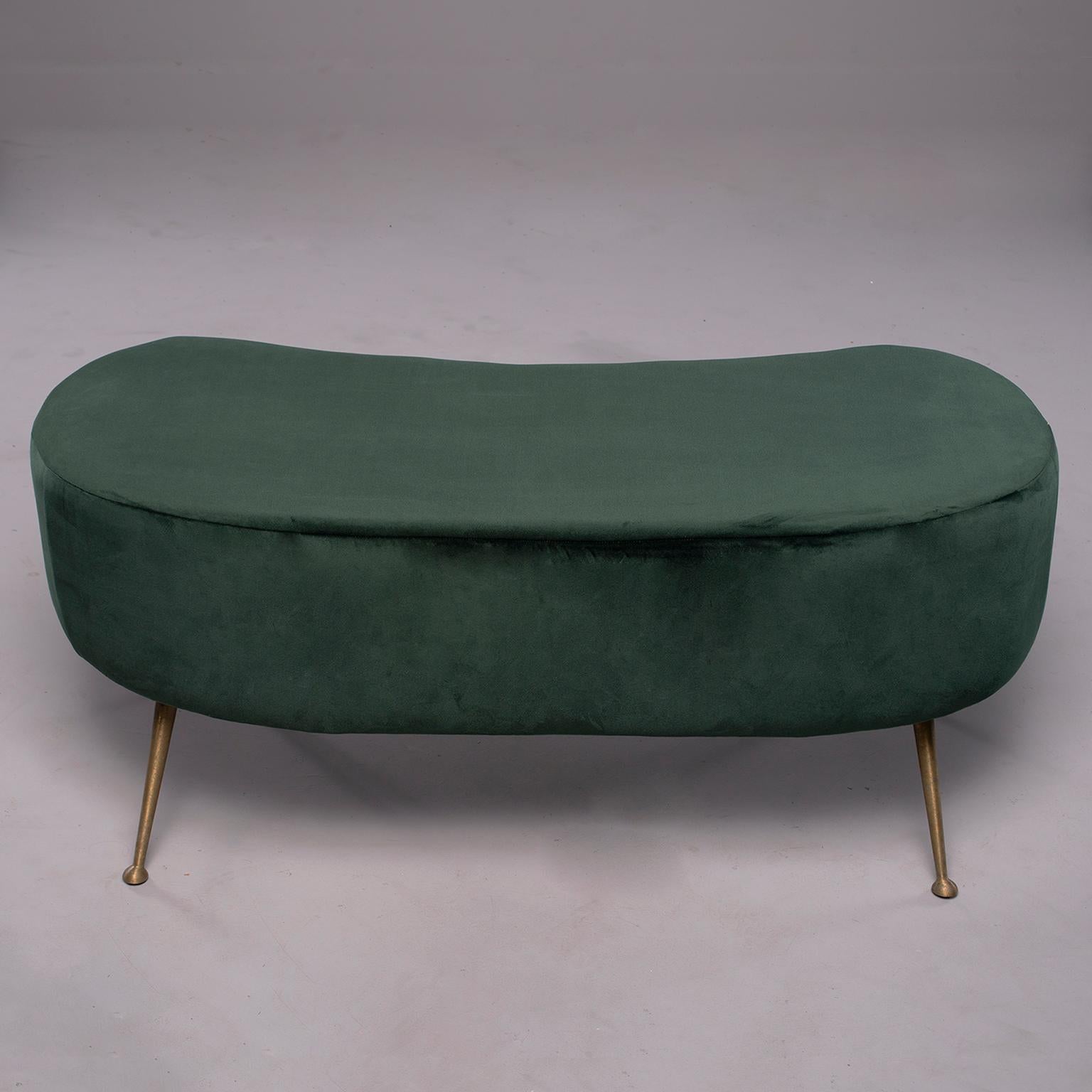 Italian upholstered bench is kidney shaped with narrow, gold metal legs and feet, circa 1960s. Fabric has been recently replaced and is an emerald green short-napped synthetic velvet. Two stools are available at the time of this posting. Sold and