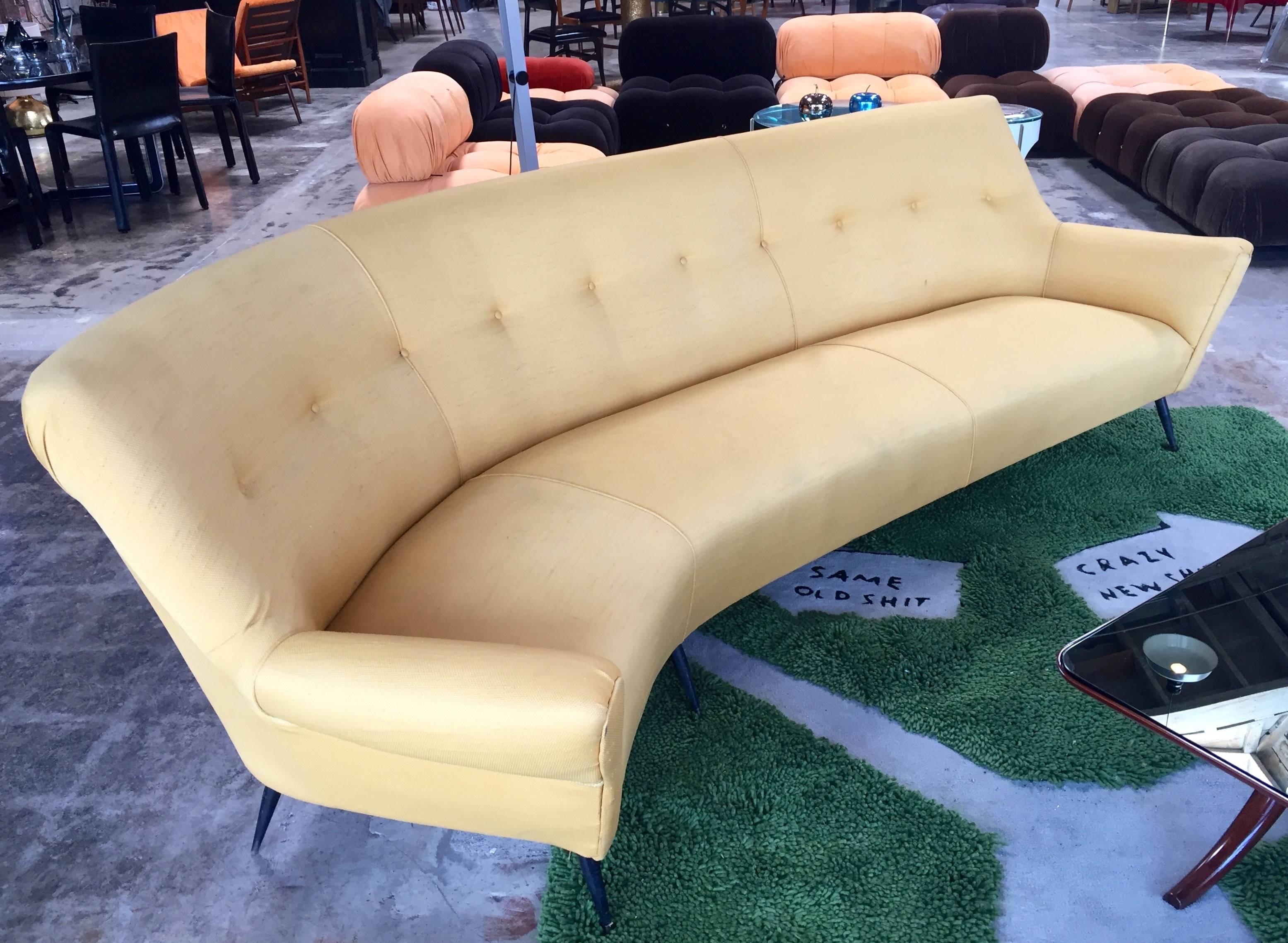 Beautiful Italian 20th century vintage curved four-seat sofa composed of six splayed polished legs, large wing shaped arms and a statement high back in the style of Ico Parisi.
Rare and original yellow fabric!