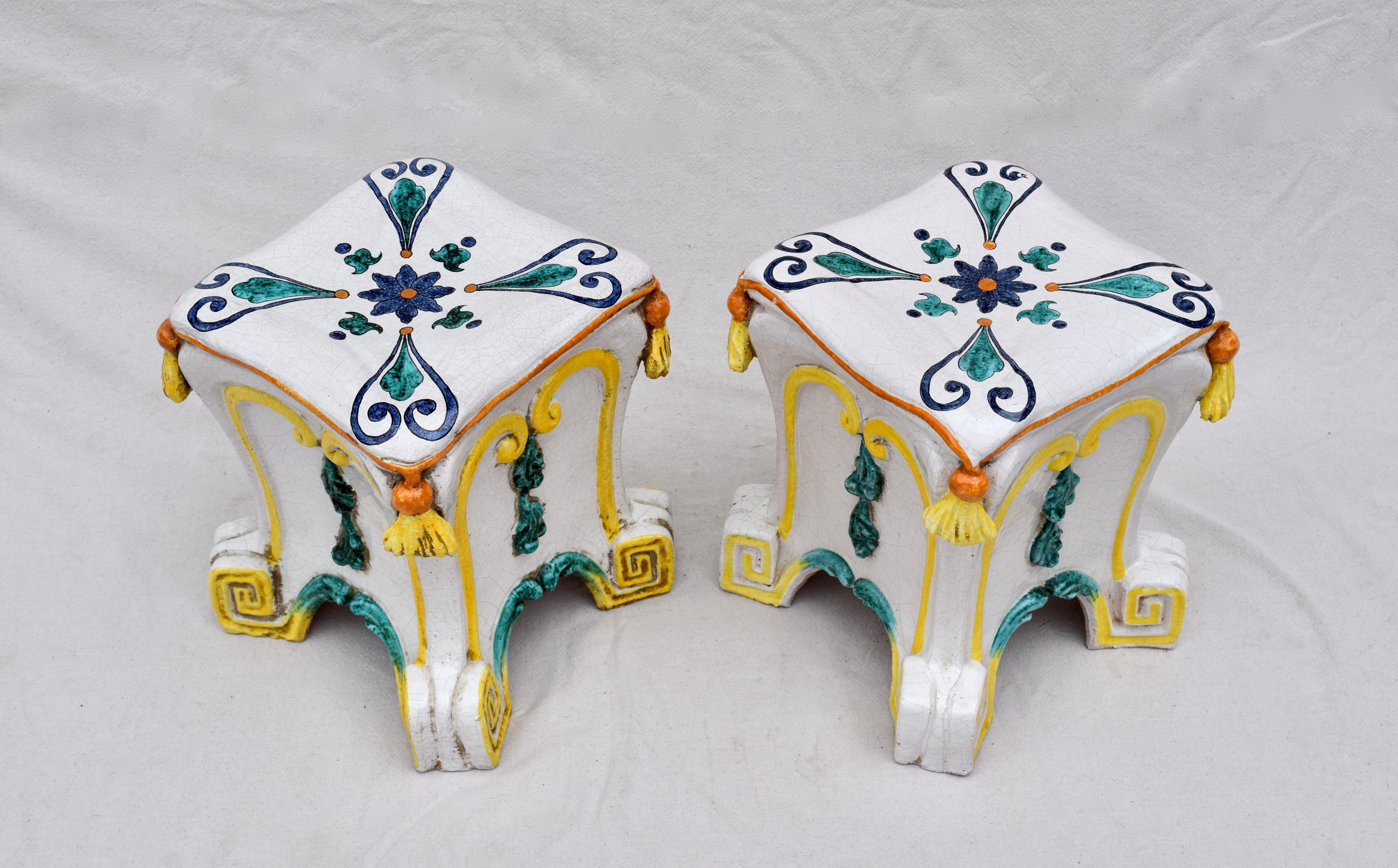 A pair of vibrantly painted and glazed terracotta garden stools with faux tassel cushions & Greek key motif base. Each is hand signed and numbered. Single family owned and imported from Italy in the 1970s.