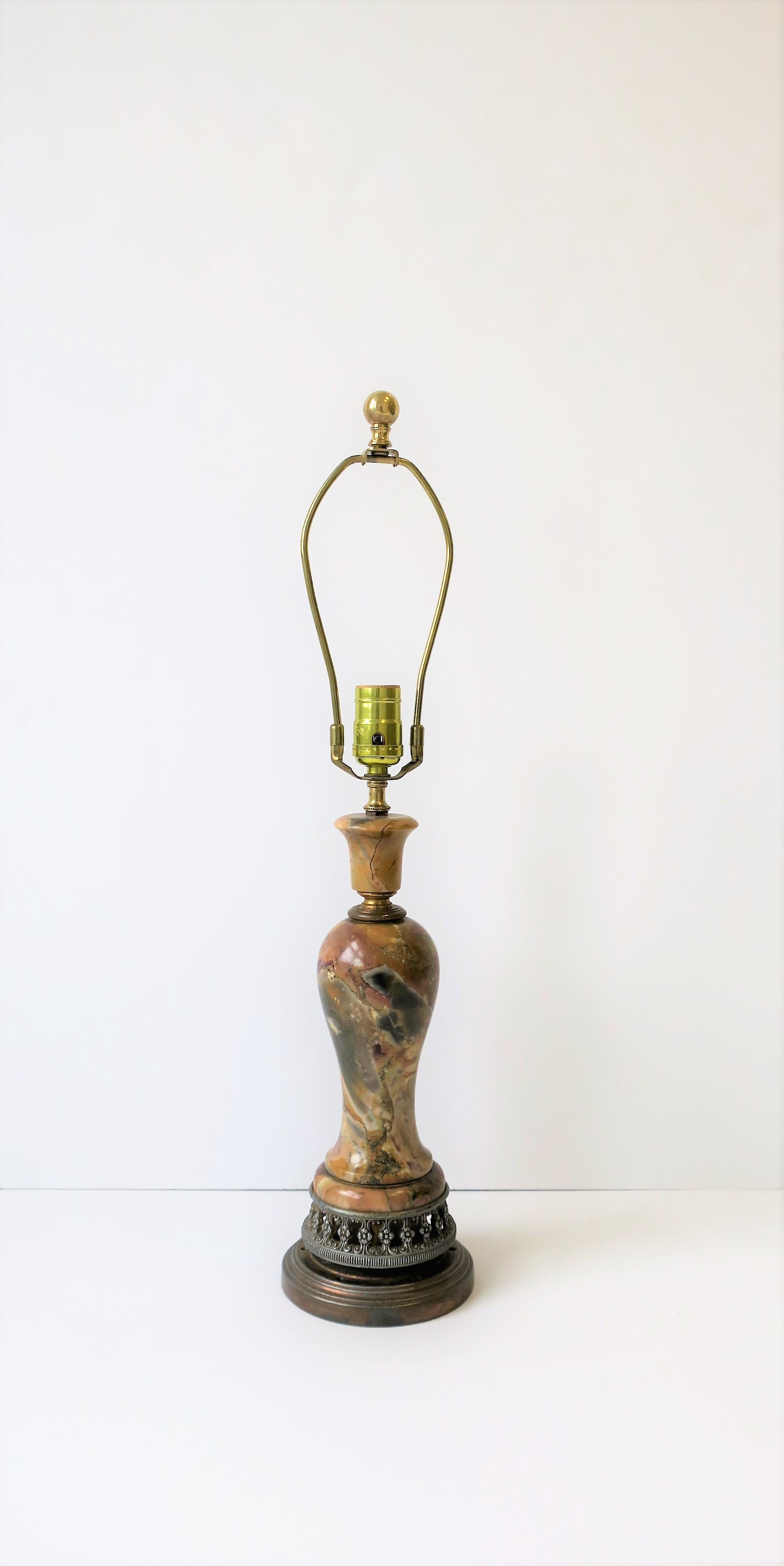 A substantial small to medium sized Italian multicolored solid marble desk or table lamp with decorative metal base, circa mid-20th century, Italy. Multicolored marble in neutral and earth tones finished with detailed metal base. In fine working