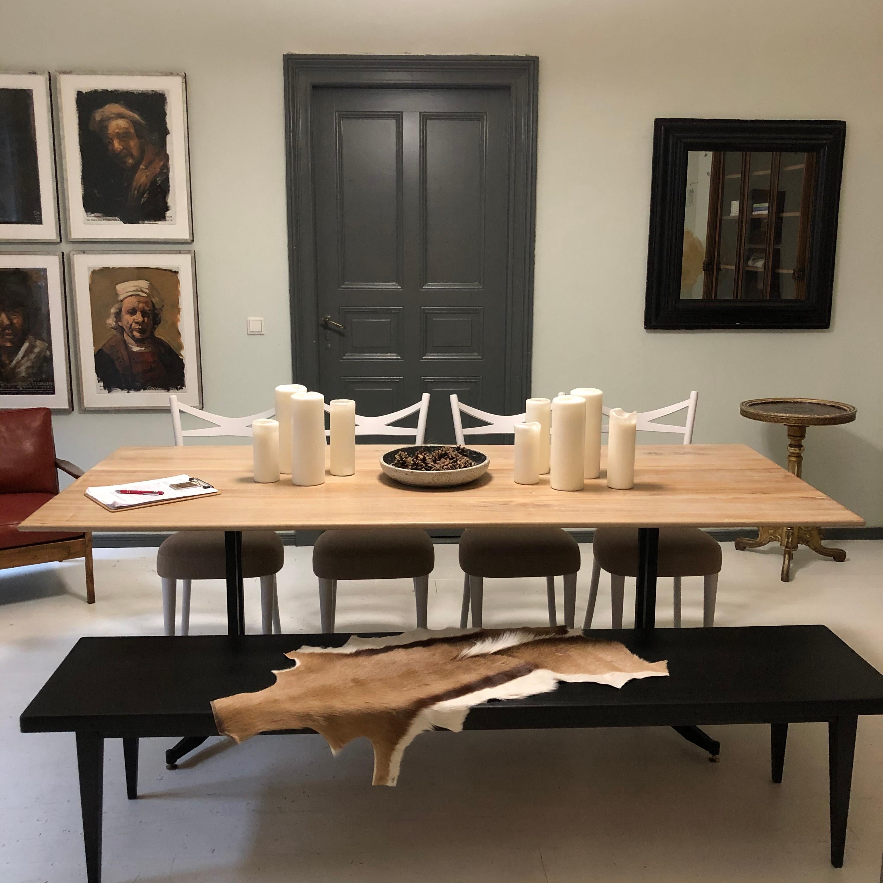 This beautiful midcentury Italian dining table has an elegant black lacquered metal base and the limed elm top is made out of old church benches.

A unique piece which is a great eye-catcher for your antique, modern, space age or mid-century