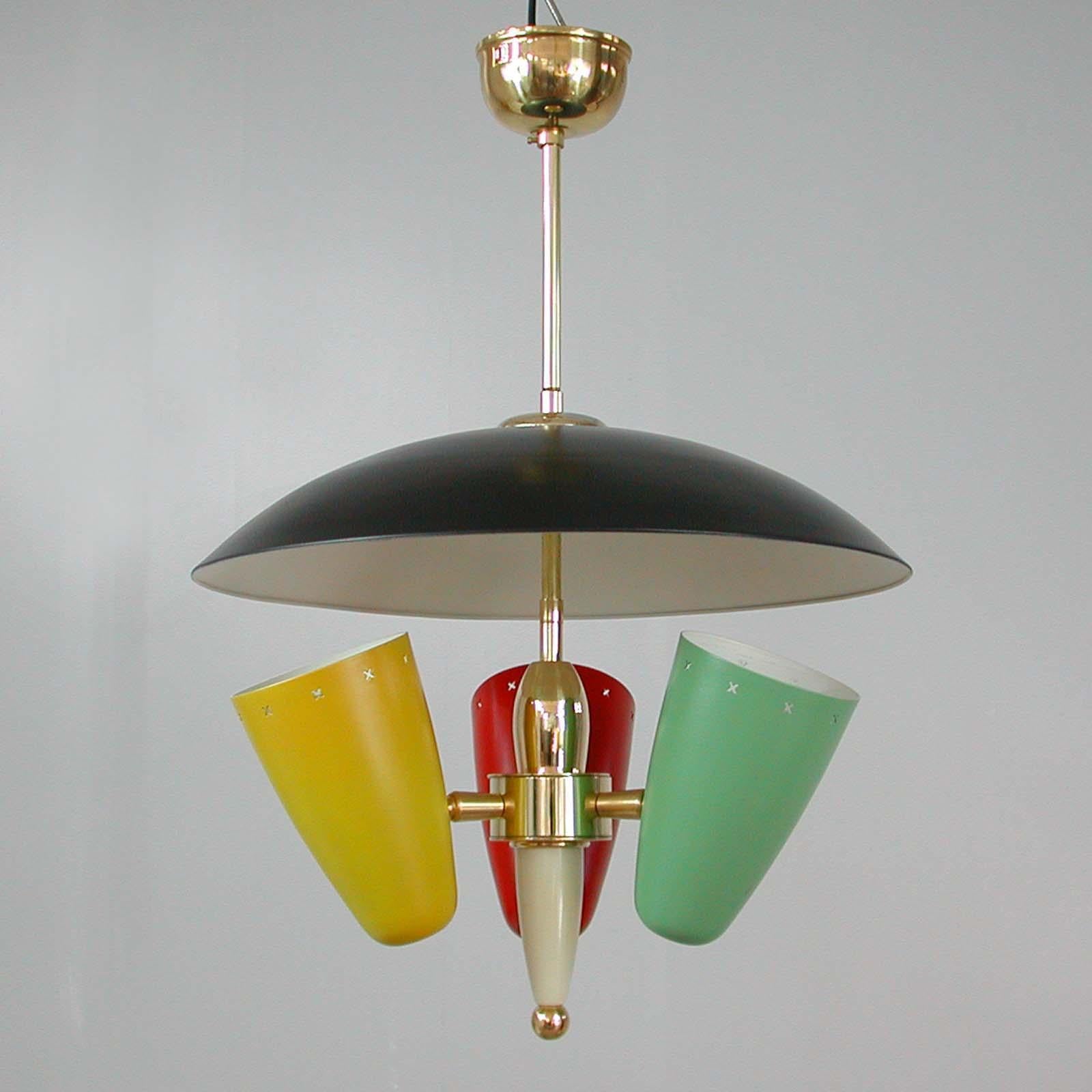 This very rare multi-color reflecting chandelier was made in Italy in the 1950s in the manner of Stilnovo.

The chandelier has got three lacquered metal shades and requires one E14 bulb per shade. The colors are red, yellow and mint. The top