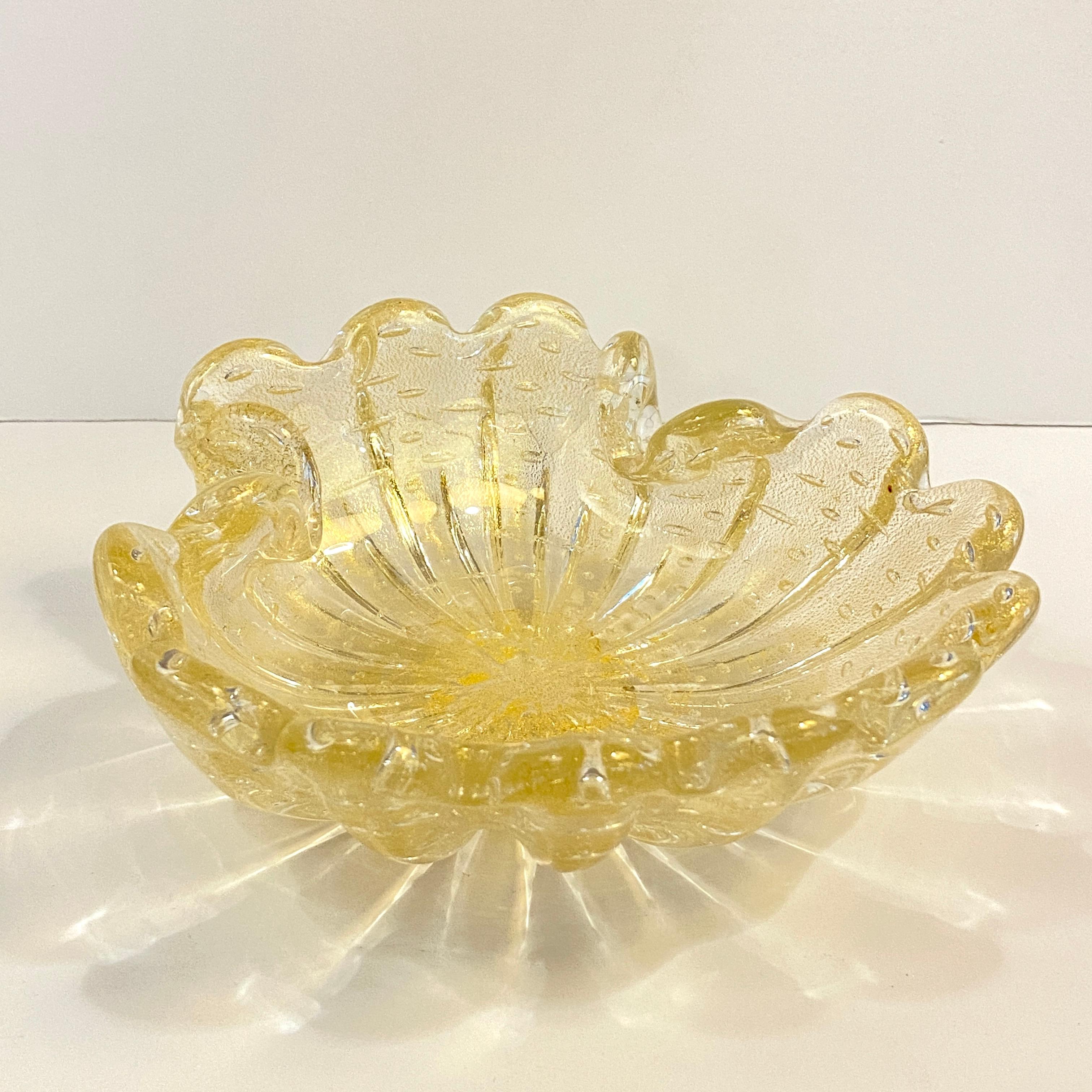 Midcentury, Murano, Italian, hand-blown, art glass clamshell dish or ashtray is embellished with gold flecks creating an overall light champagne tone that shimmers beautifully in the light. The dish also features the bullicante technique for a