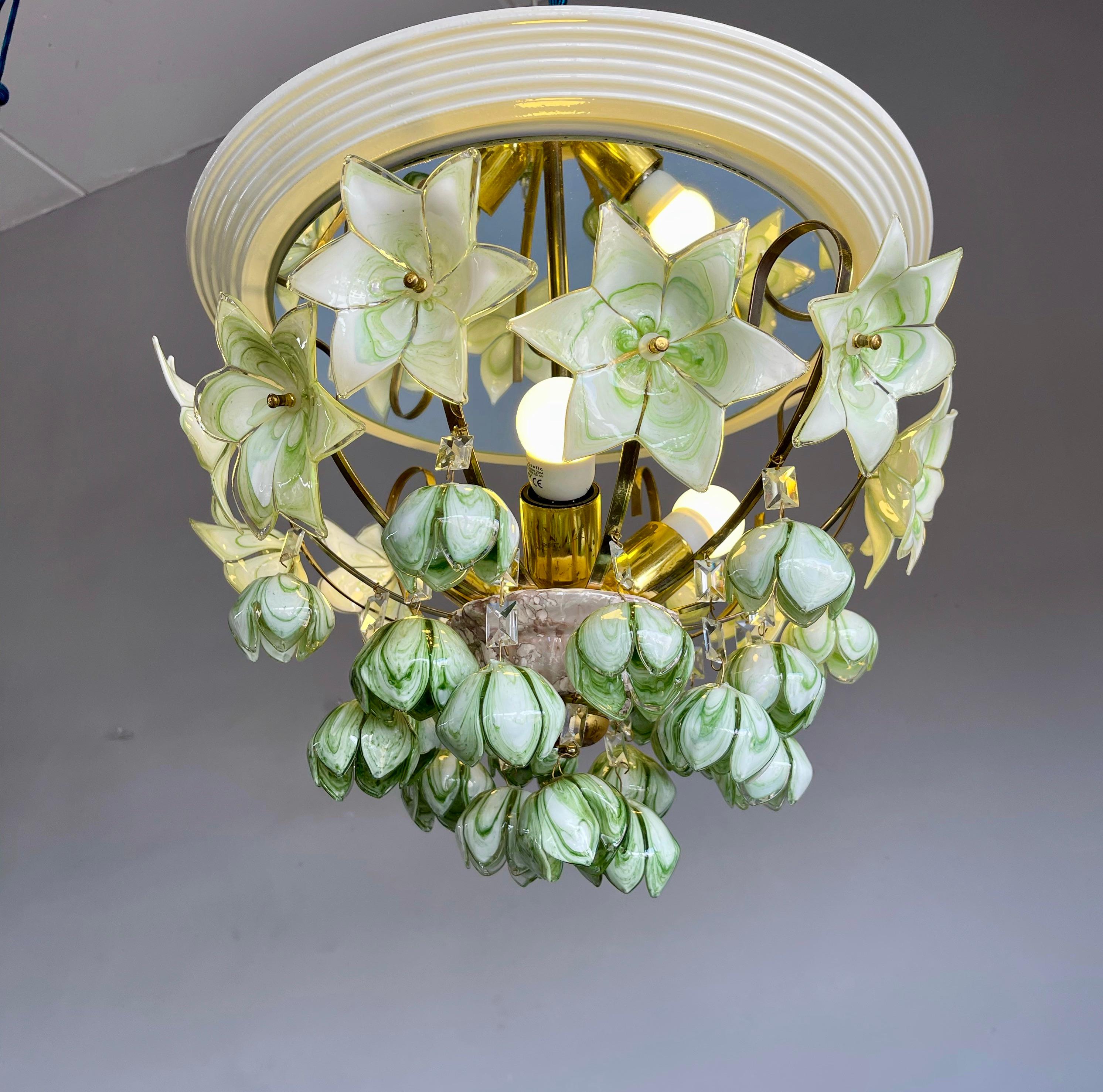 Mouth blown green glass flower bouquet light fixture with integrated ceiling mirror.

If you are looking for a striking and extraordinary light fixture to grace your living space then this, Italian work of lighting art could be the one for you. This