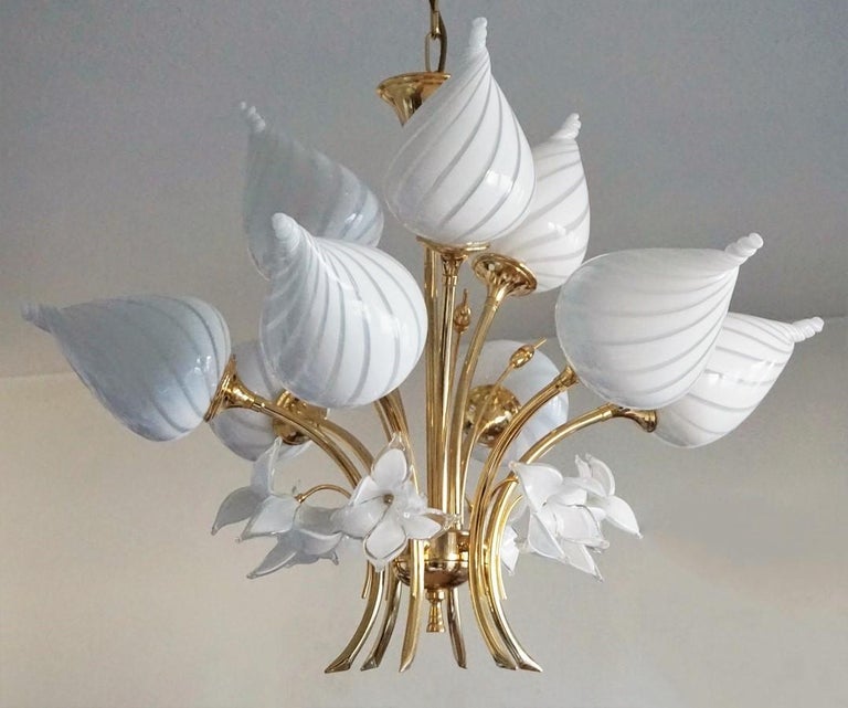 A large hand blown Murano glass and gilt brass bouquet chandelier, nine-arm with large drop shape globes, decorated with glass flowers, Italy, 1960s - impressive lighting effect!
The glass globes are in very good condition, brass with some wear,