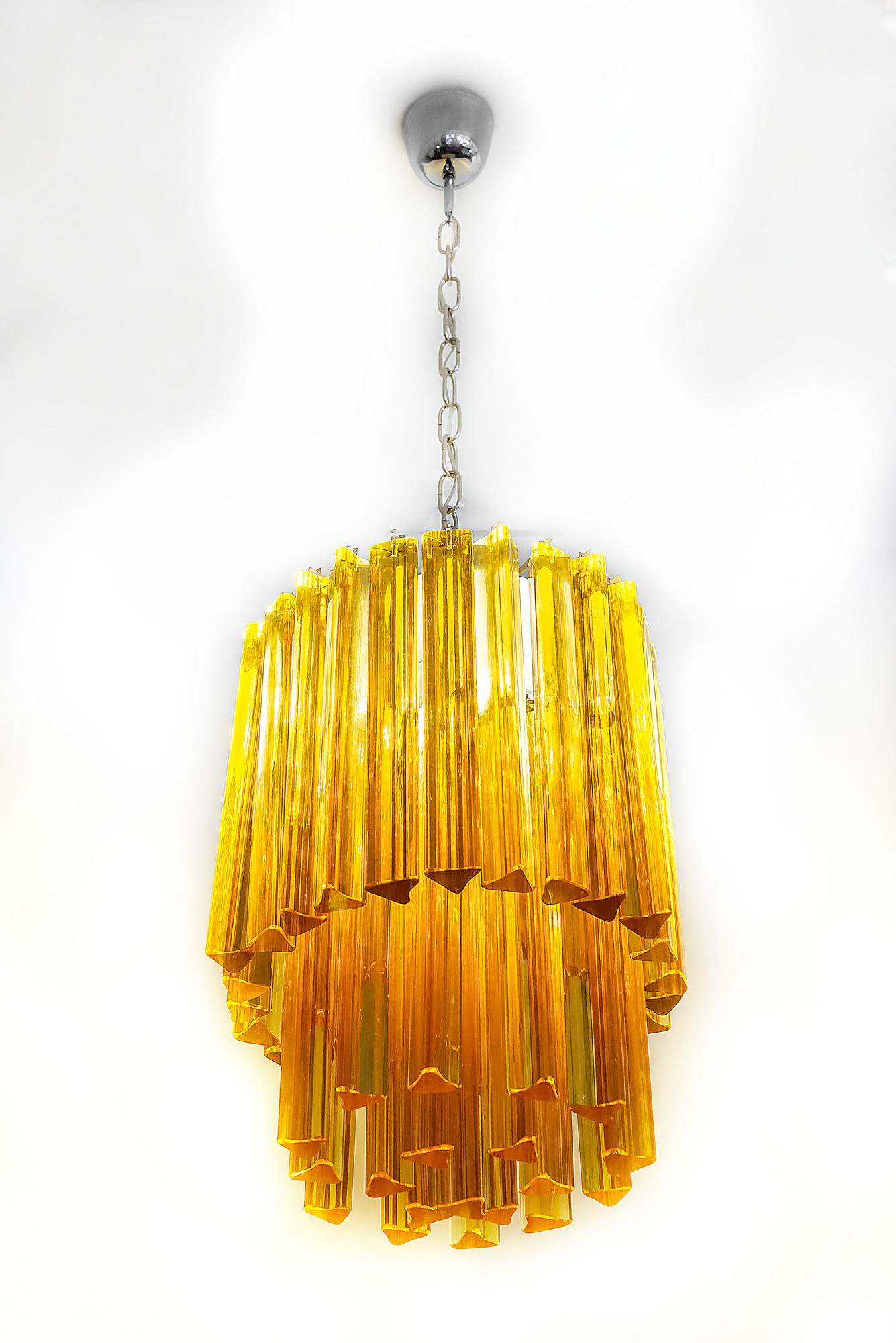 This midcentury Italian chandelier is made of solid ambra color Murano glass. It is heavy. Chandelier includes 3 pieces of E14 bulbs.
