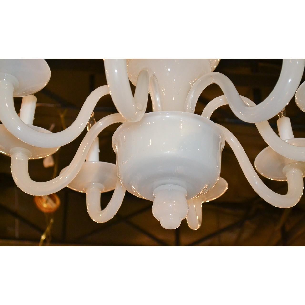 Exceptional midcentury Italian Murano milk glass chandelier with a bulbous-formed stem surmounted with eight gracefully contoured s-shaped branches and simplistic bobeche. Classic style, Classic look,

circa 1940.