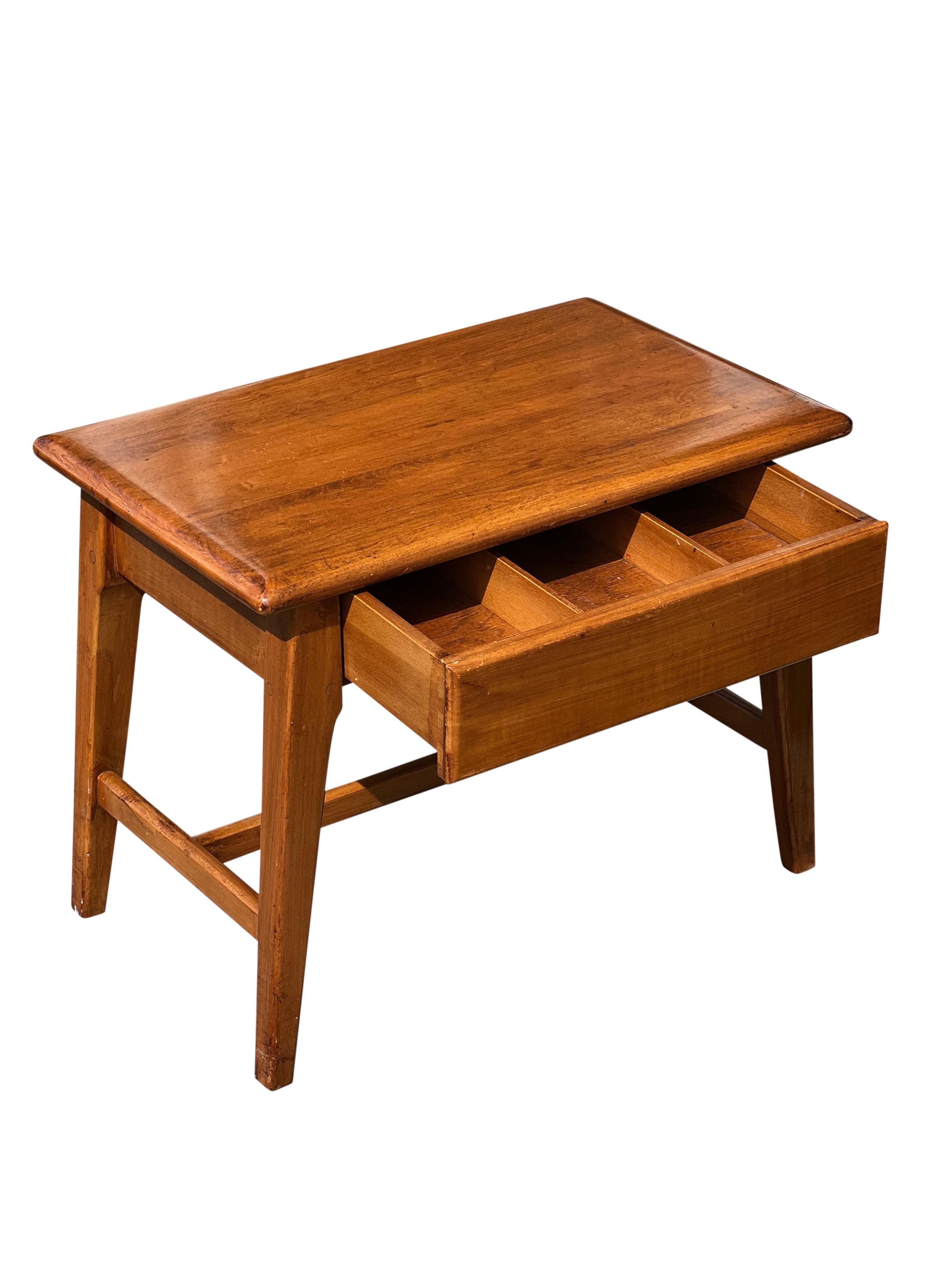 Midcentury Italian oak hardwood sewing table or stool.

Wonderful low side table or stool with a single three-section slotted drawer.  A lengthwise hand groove is carved underneath for easy open/close.  A smooth, rounded waterfall edge and splayed