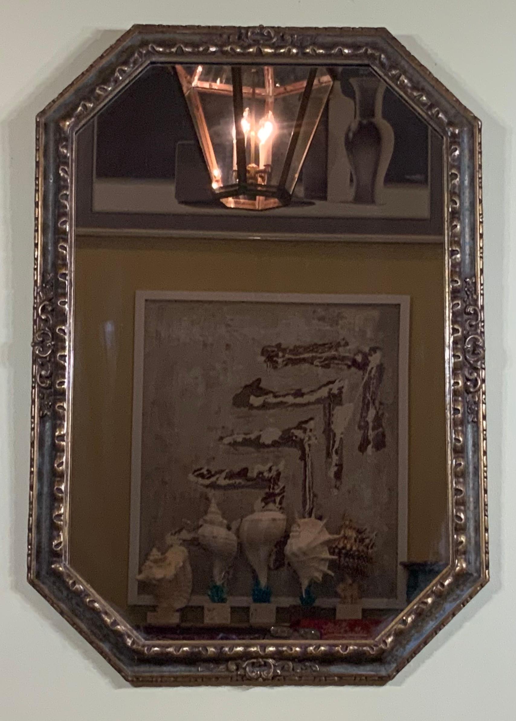 elegant antique mirror, hand crafted in Italy circa 1960 in octagon shape. the mirror features are scrolled molding around the frame and almost Invisible hand painting of vines.
The mirror is in very good condition. 
Beautiful elegant mirror for
