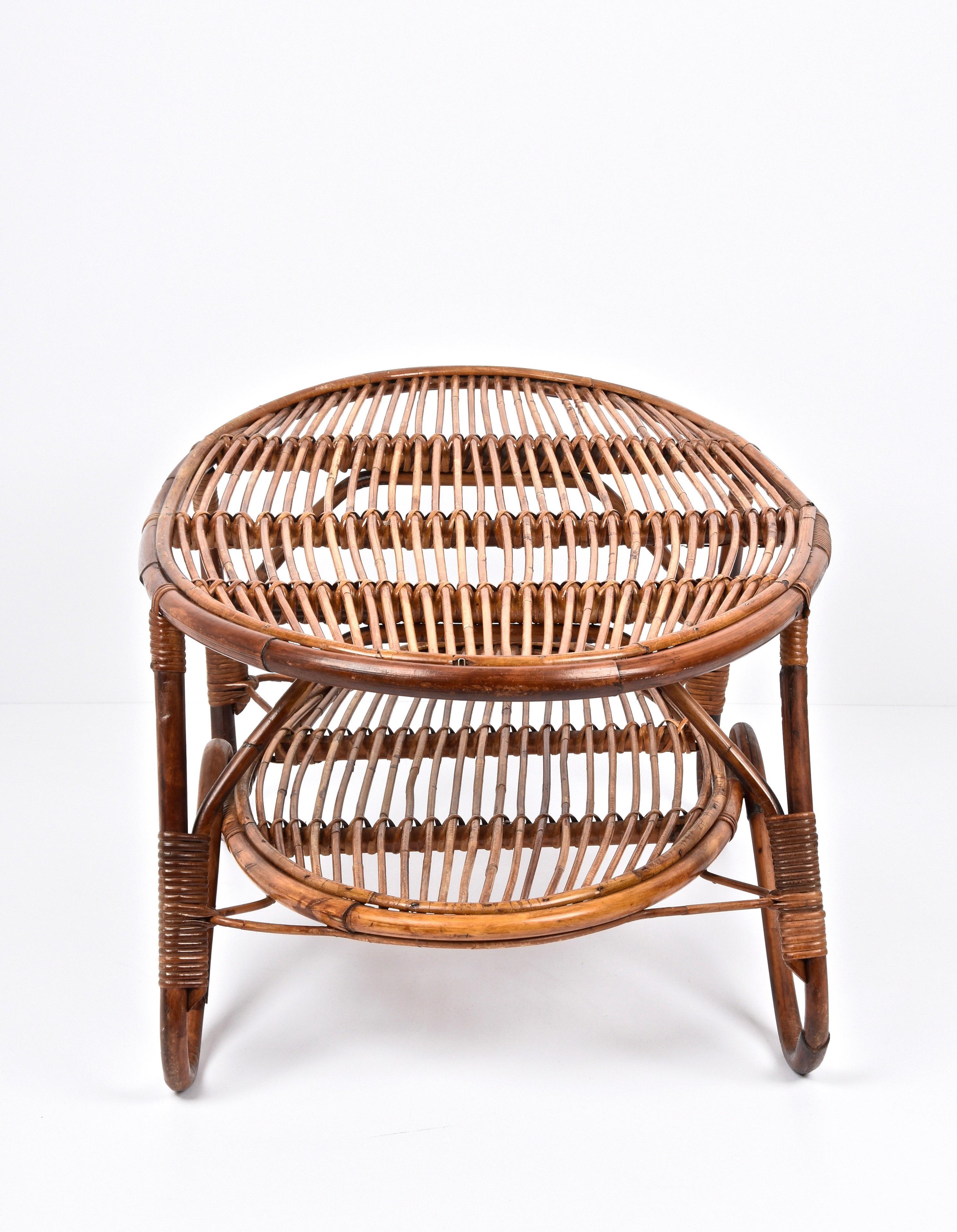 Incredible midcentury rattan & bamboo two-tier oval side table.

A wonderful coffee table with curved legs in bamboo and rattan, made in Italy during the 1950s.

This cocktail table is very useful and adaptable thanks to its design and its solid