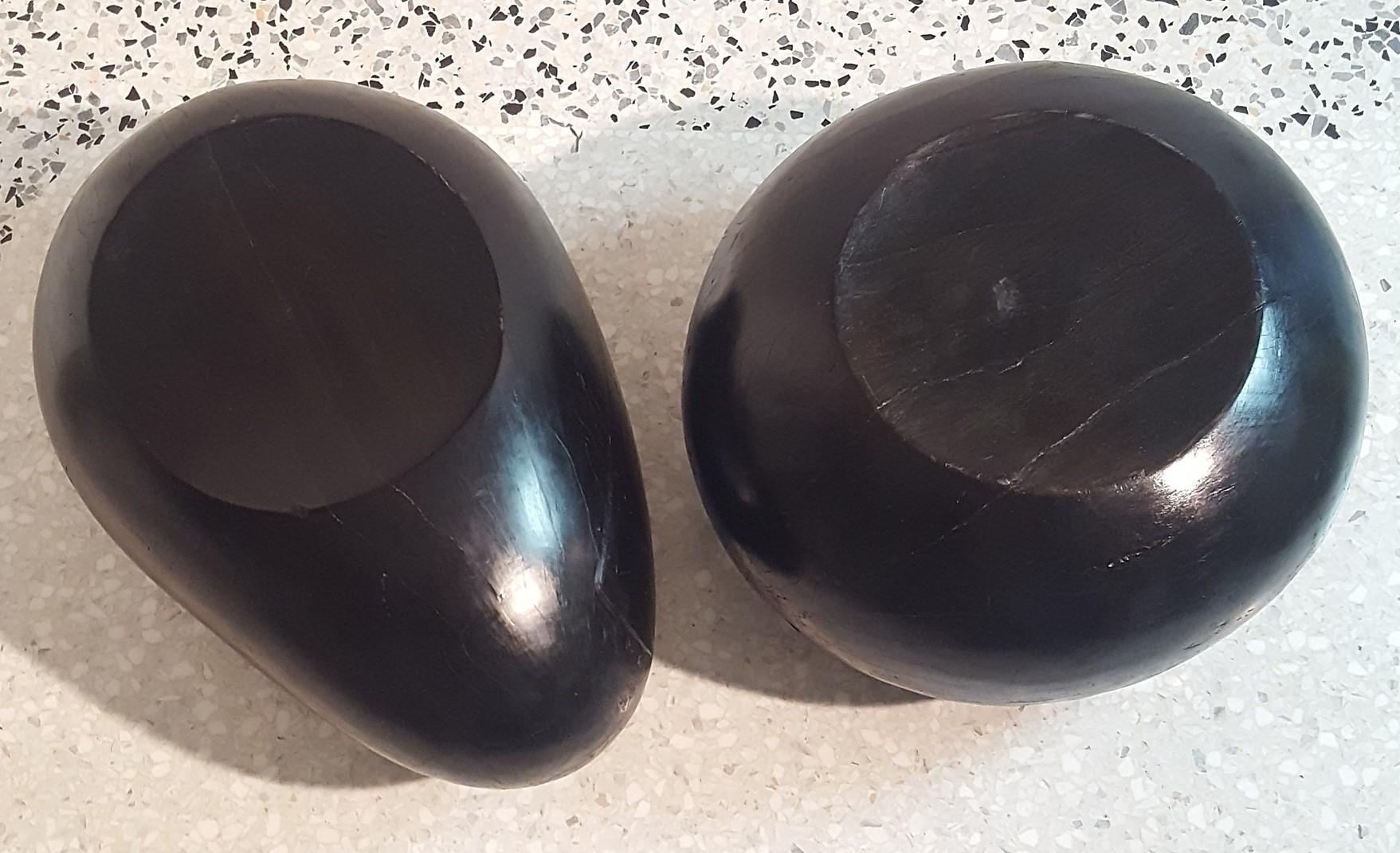 Exceptional and rare set of two sculptural solid black lacquered wood seats made in one massive turned piece of wood.
One with circular shape (diameter 60 cm) and the second with egg shape. (70x 50 cm) height 40
The archetypal form gives them a