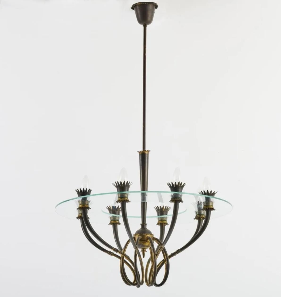 Midcentury Italian Patinated Brass Fontana Arte Pendant Light, attributed to Pietro Chiesa, 1941. 

Sculpted from patinated brass tubing and sheeting, a ring of transparent art glass encircles the lights. 