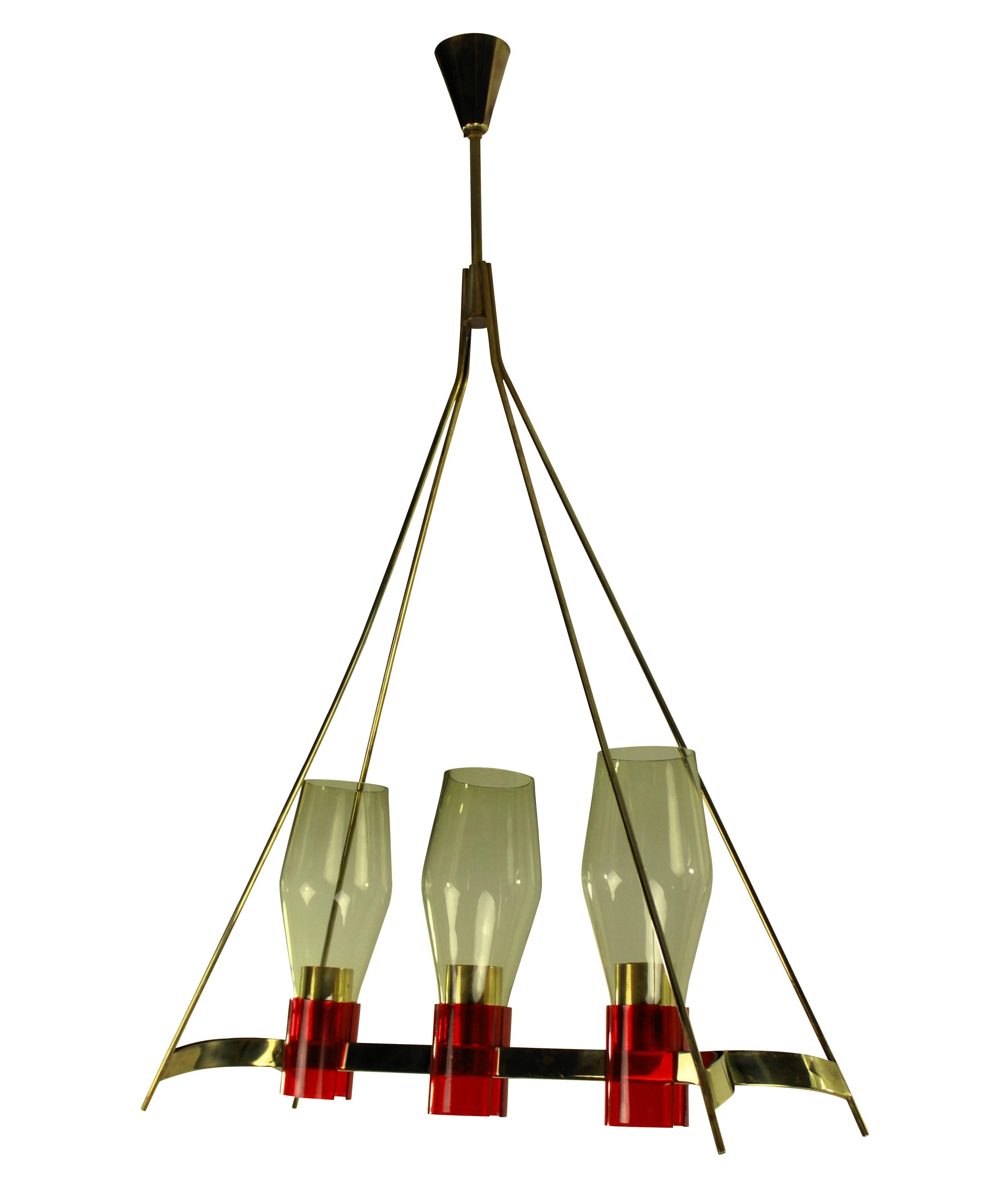 An Italian hanging light of unusual design, in brass with red detailing and pale yellow glass shades.

 