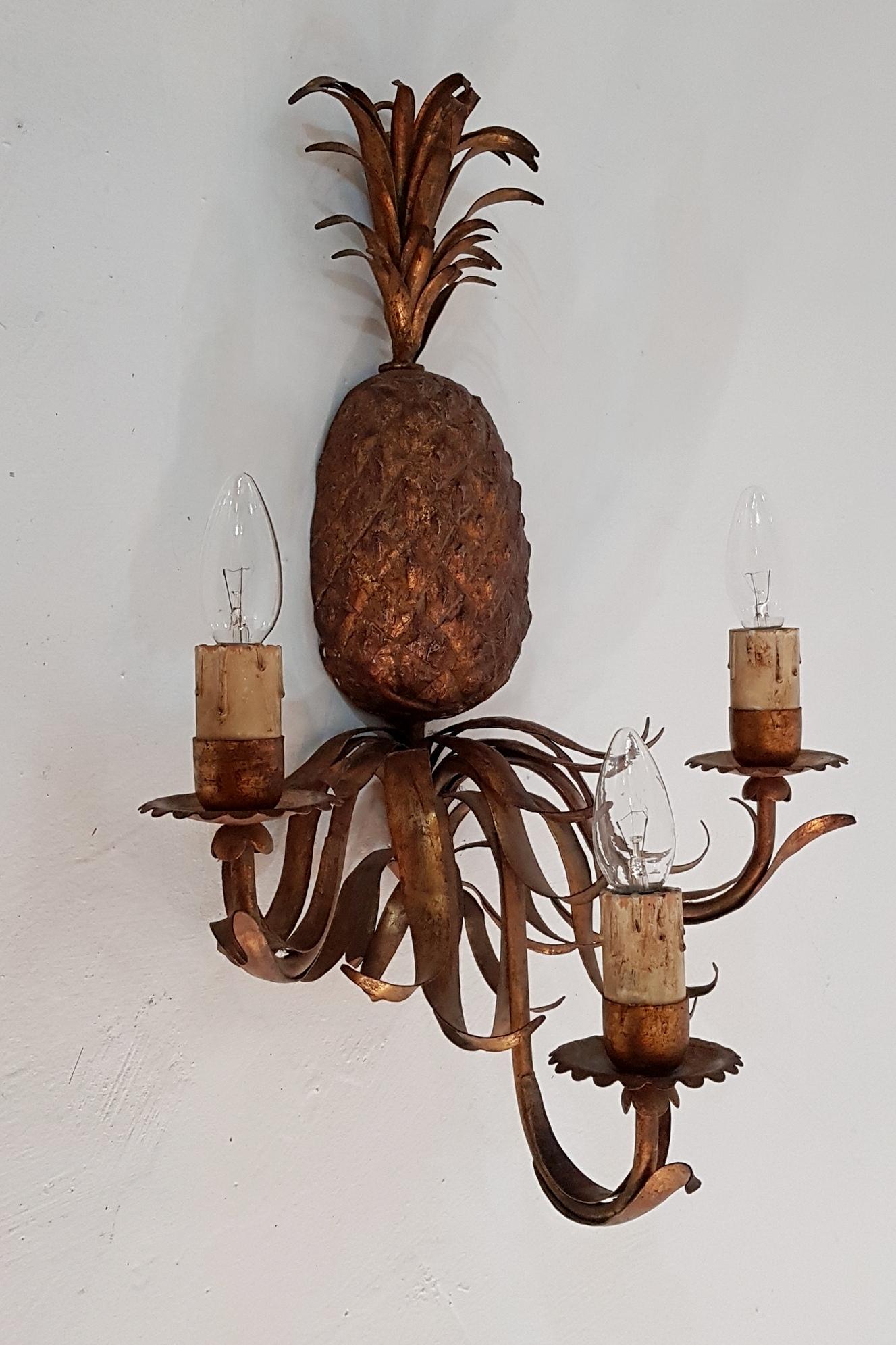 Large single wall sconce in the shape of a pineapple with three arms each holding a faux candle for an E27 lightbulb.