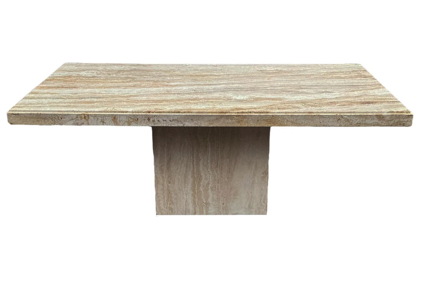 A simple modern travertine marble dining table circa 1980s. It features solid slab Travertine construction with thick apron edge. Gorgeous highly grained Italian travertine. Clean ready to use condition. 
