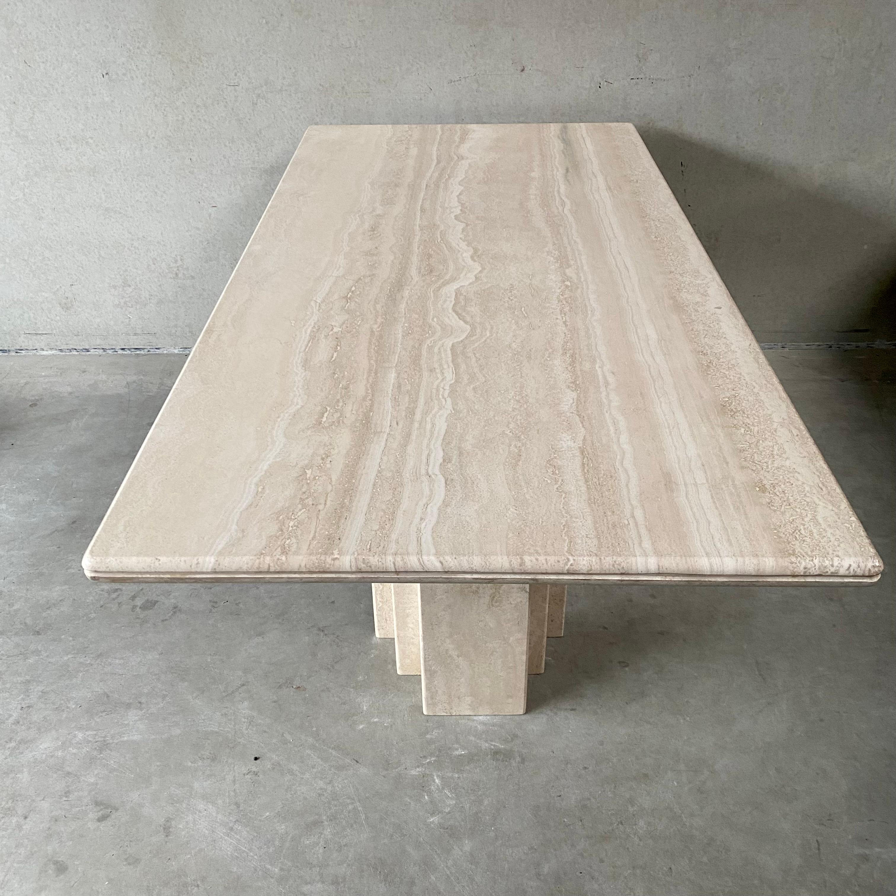 Introducing our stunning rectangular Travertine dining table, a true masterpiece of Italian design from 1980. Crafted with exquisite attention to detail, this table features a luxurious 4 cm thick travertine top that is sure to make a statement in