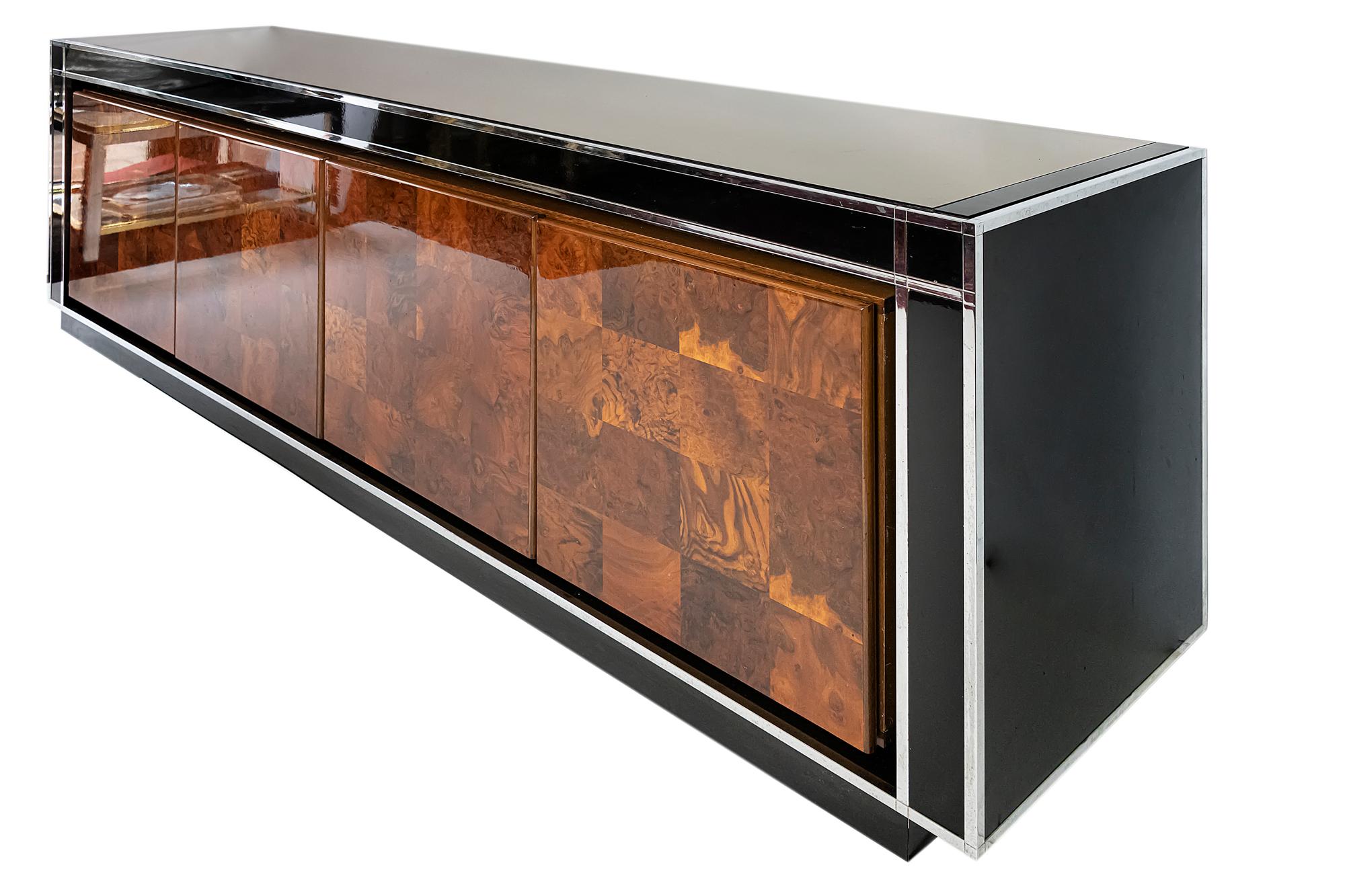 Midcentury Italian sideboard by Willy Rizzo.
Sideboard is finished with black glossy surface decorated with chrome details and glass top.
It has four doors with internal shelves.
Very good vintage condition.

              