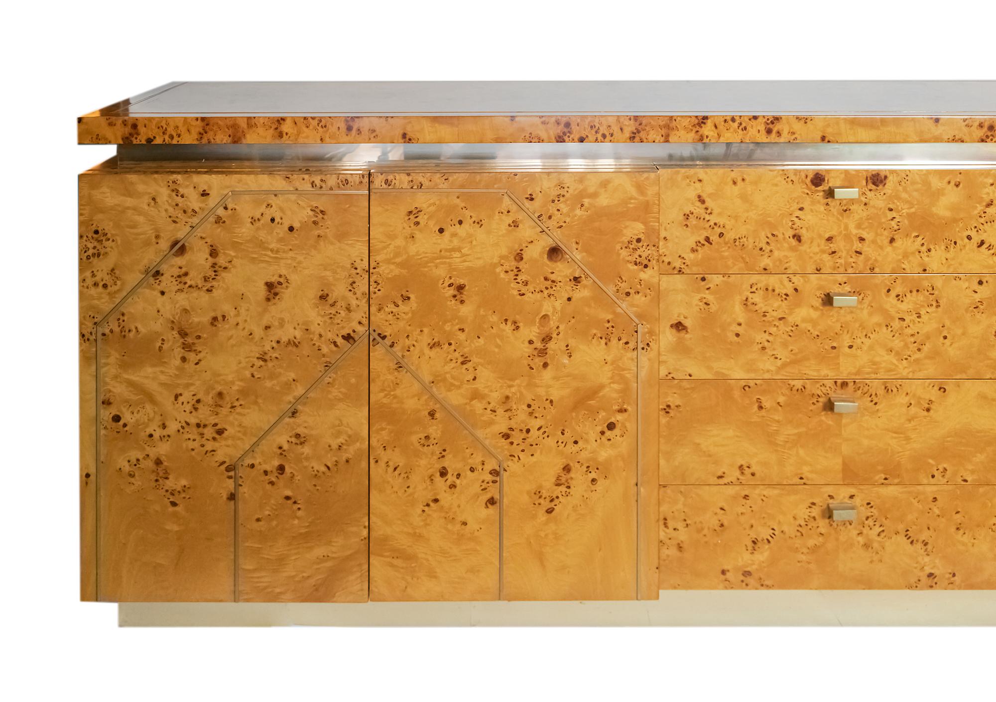 Italian vintage burl wood verneer sideboard or commode by Willy Rizzo from 1970s.
The top and doors are decorated with brass stipes, the drawers with brass handles.
Brass detail is along all the horizontal space between the top and doors part, as