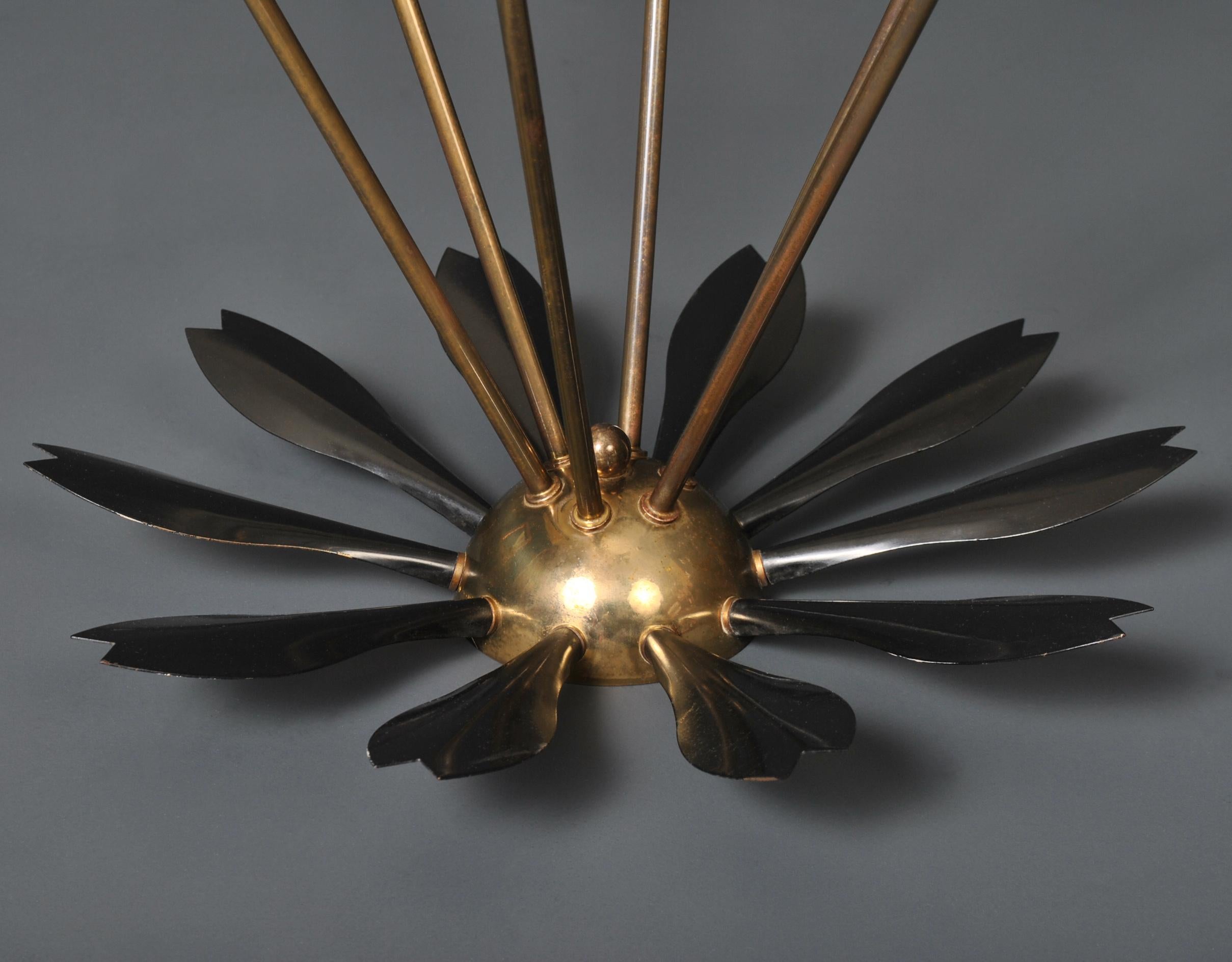 A very unusual version of an Italian Sputnik ceiling light, circa 1950. Black enamel painted metal with perimeter leaf motif, brass base and arms with classic Italian colored lampholders. Fully re-wired.
A superb piece of Midcentury lighting.
    