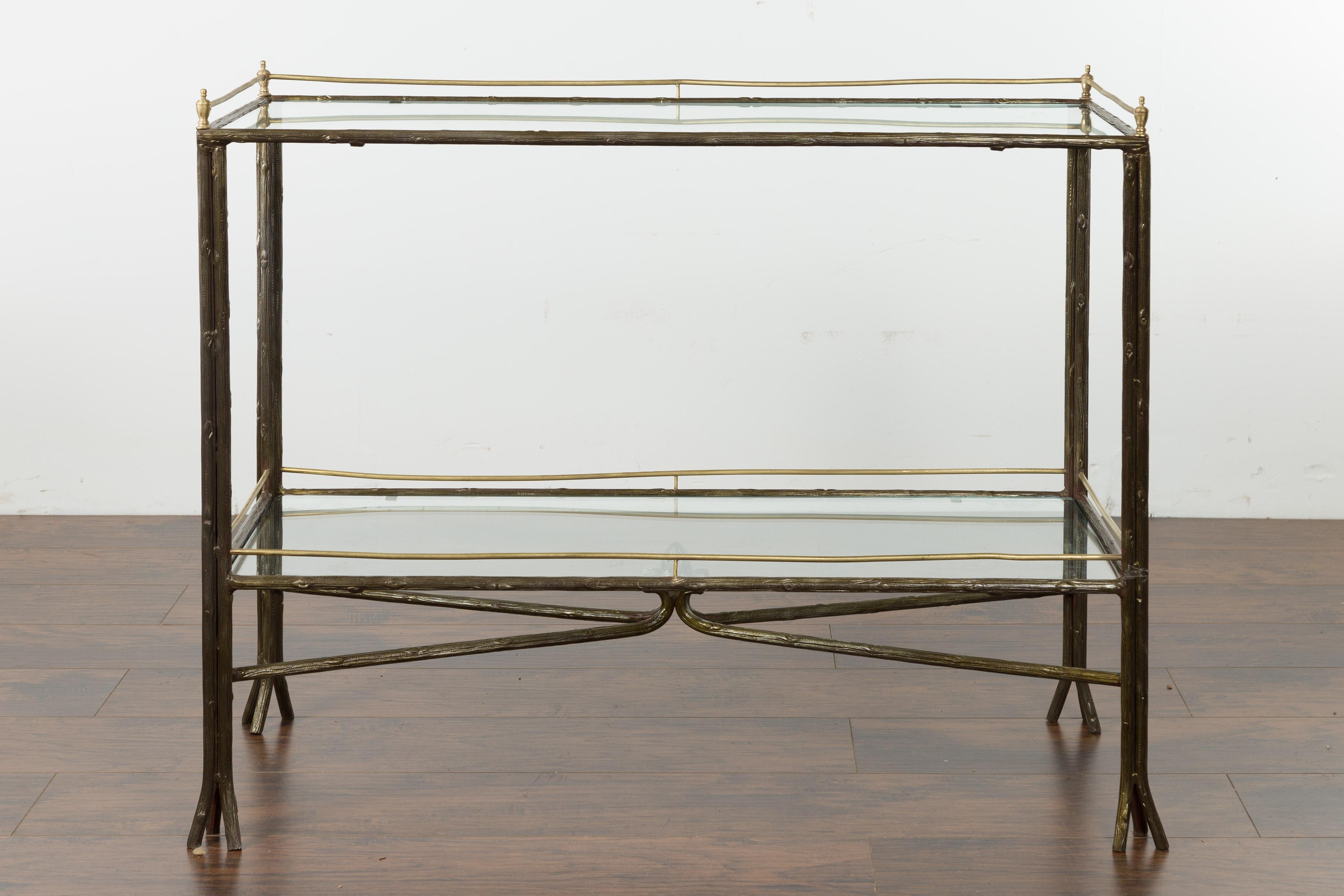 A vintage Italian steel and brass faux bois table from the mid-20th century, with glass top and shelf. Created in Italy during the midcentury period, this steel table charms us with its faux bois structure supporting a glass top and shelf. Accented