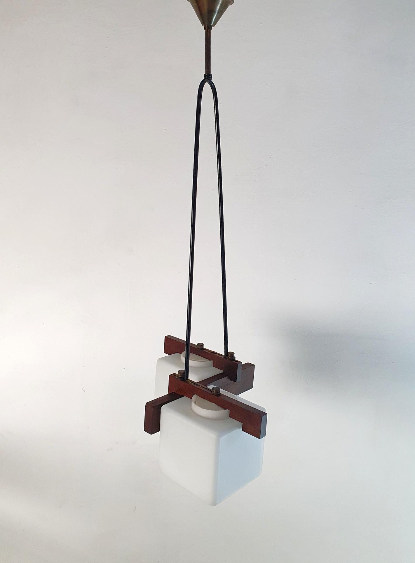 Midcentury 1960s pendant with four lights fitted for E14. Original lampshades made in white opaline glass attached on black powder coated aluminium and brass with teak details. Fully functioning and in great condition.

