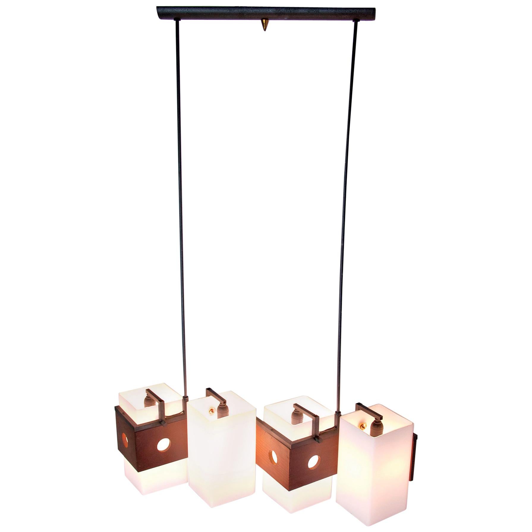 Midcentury 1960s pendant with four lights fitted for E14. Original lampshades made in white opaline glass attached on black powder coated aluminium and brass with teak details. Fully functioning and in great condition.

 