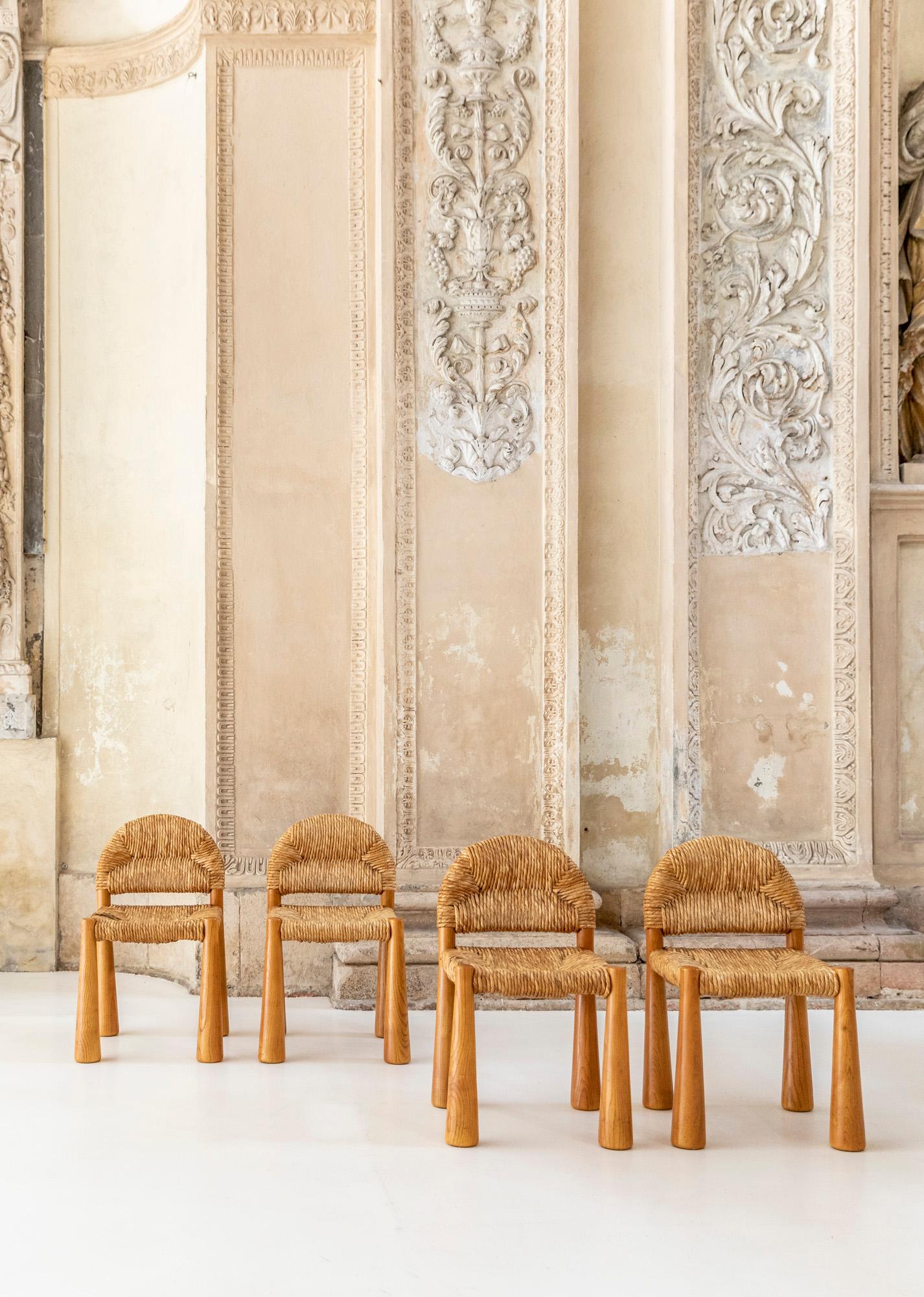 Toscanella wooden chairs designed by Alessandro Becchi. 
Beautiful chairs with straw back and seat characterized by sculptural cone-shaped legs. 
Italy 1960.