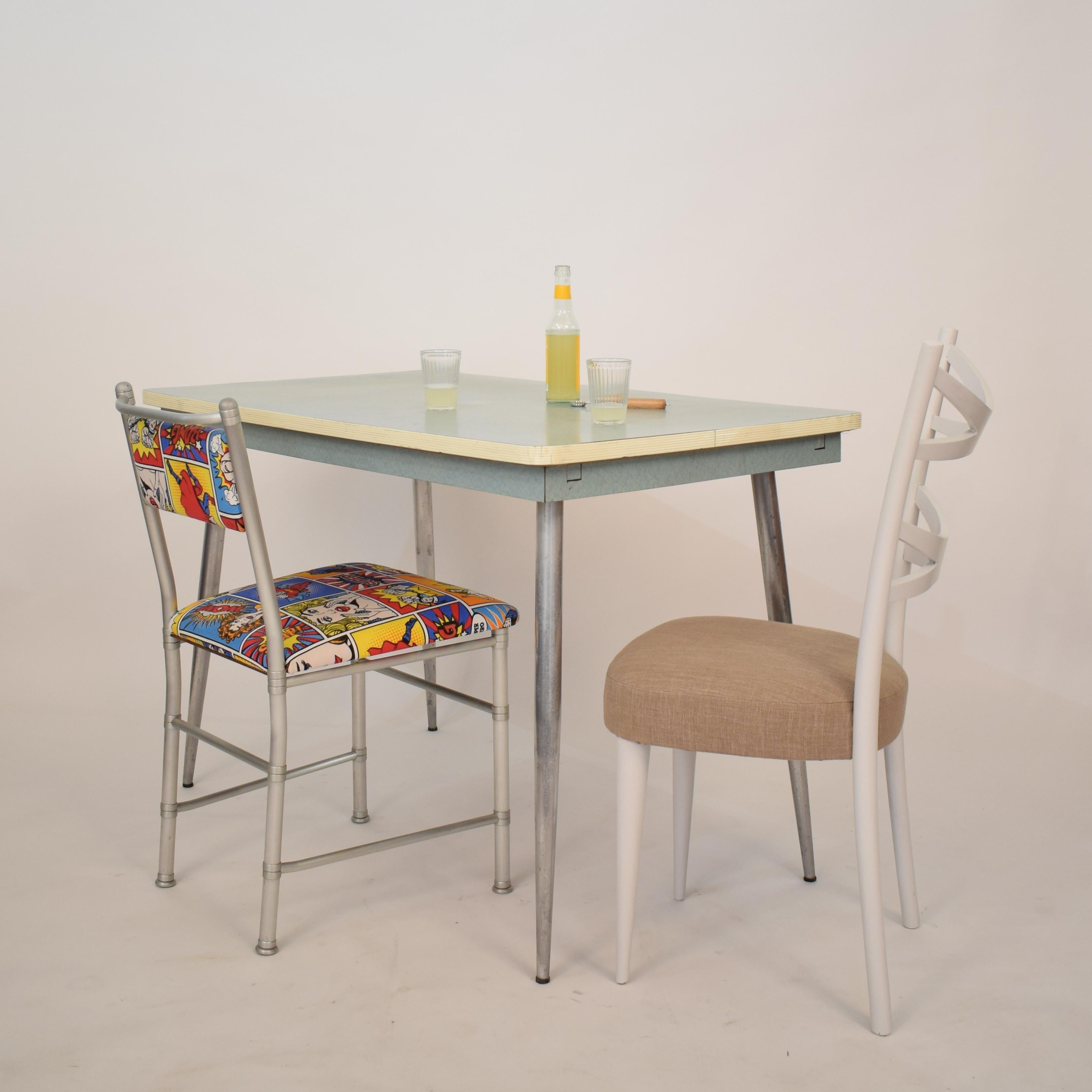 This authentic and beautiful midcentury Italian kitchen dining table was made in the 1950s.
It is a very nice original condition with great patina.
The top and the edge are made out of wood and is veneered with turquoise Formica.
It comes with