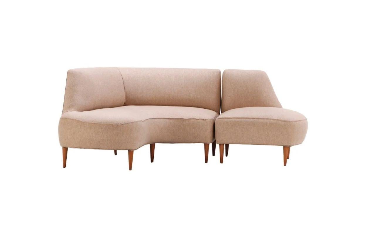 Sculptural 2-piece asymmetric sofa, midcentury Italian, circa 1950. Each piece can serve as stand-alone seating. Upholstered seat and back, carved wood tapered legs. 