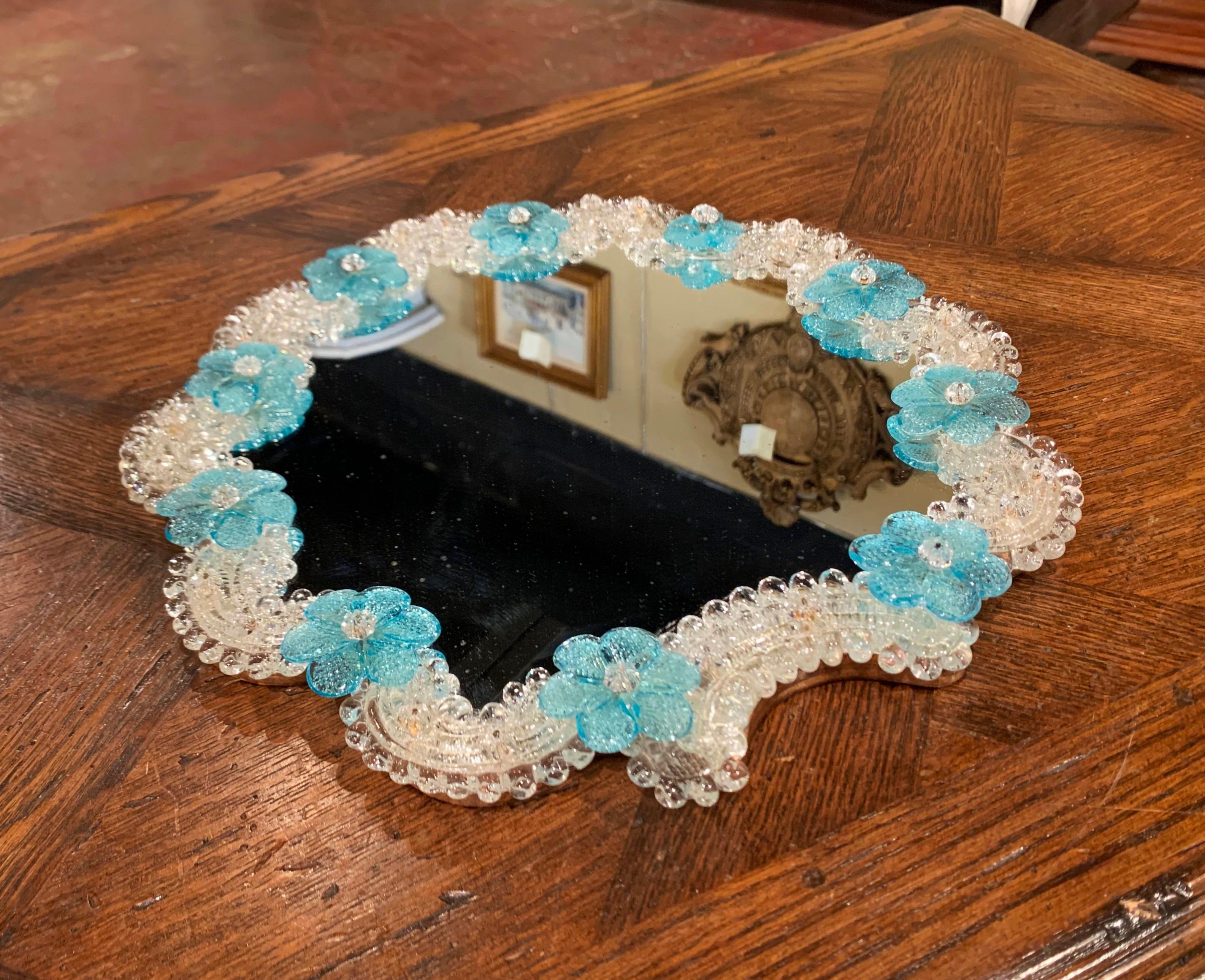 This elegant mirrored tray table was created in Murano, Italy circa 1960, the scalloped display tray with wooden bottom is decorated with handmade clear and light blue Bohemian flowers. The decorative tray is in excellent condition; use it in a