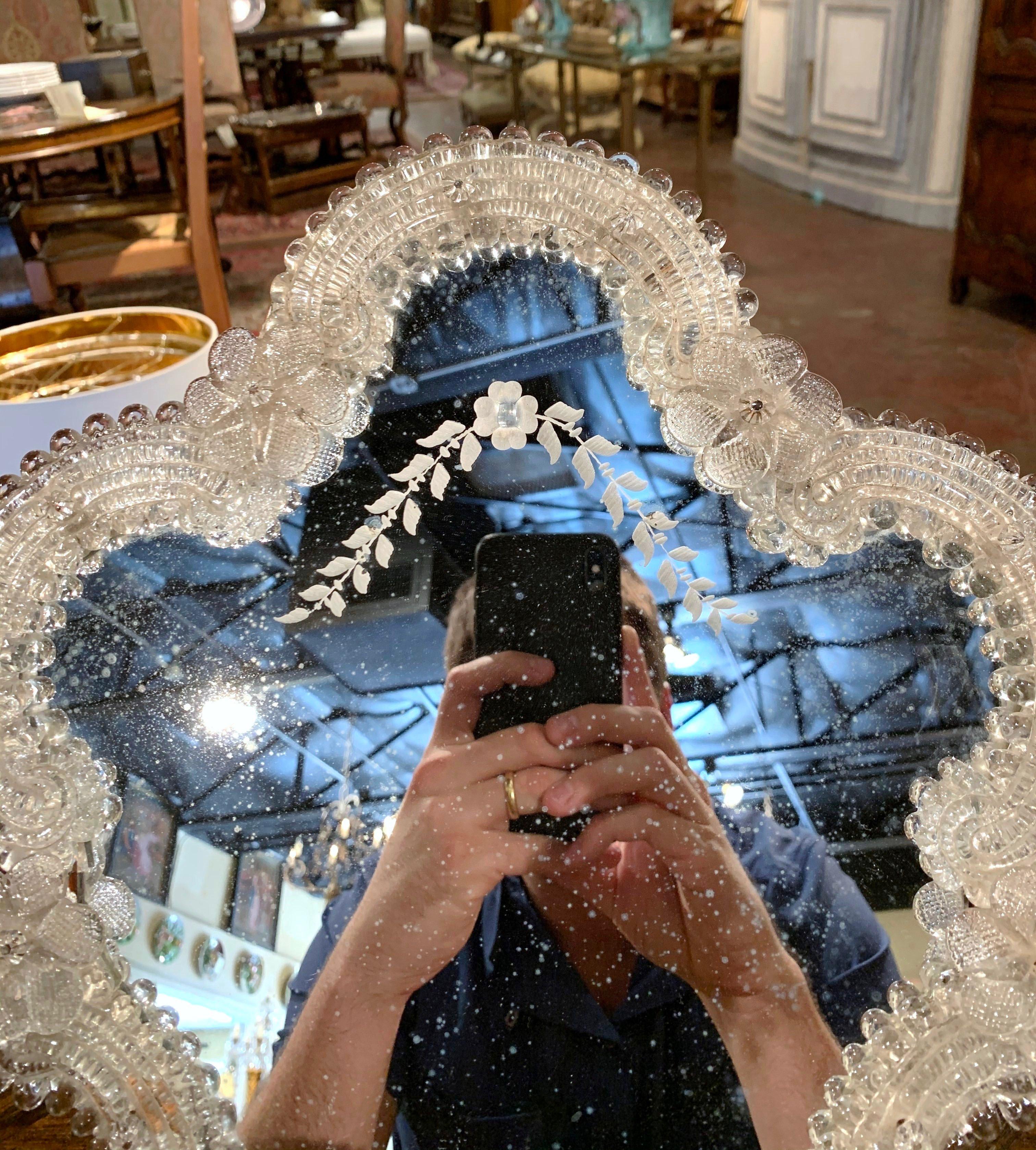This elegant table mirror was created in Murano, Italy circa 1960, the free standing vanity mirror with wooden back is decorated with handmade clear Bohemian flowers and leaves. The decorative mirror is in excellent condition and further embellished