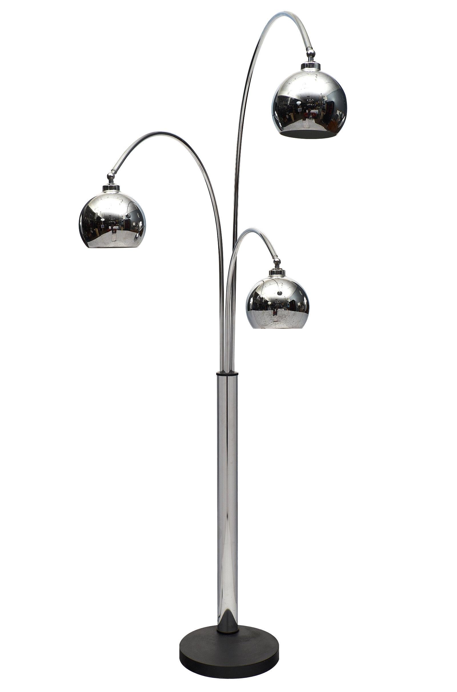 Italian vintage midcentury arc lamp with three arcing chrome lights on independently adjustable arms by Guzzini. Each chrome shade is also adjustable up and down. Rewired for the US. This iconic floor lamp is the perfect loft element.