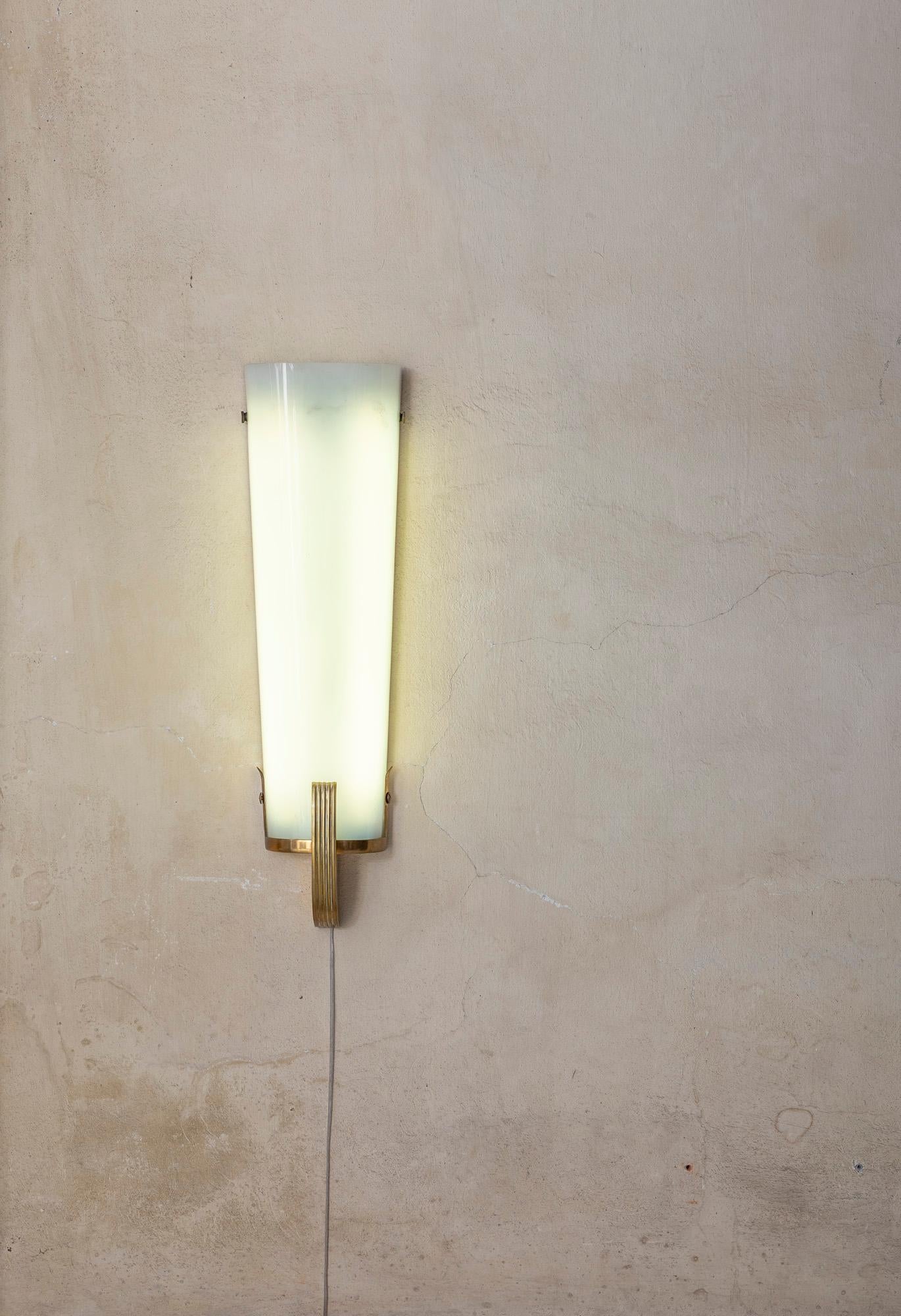 Huge brass and perspex wall light.
Elegant shape.