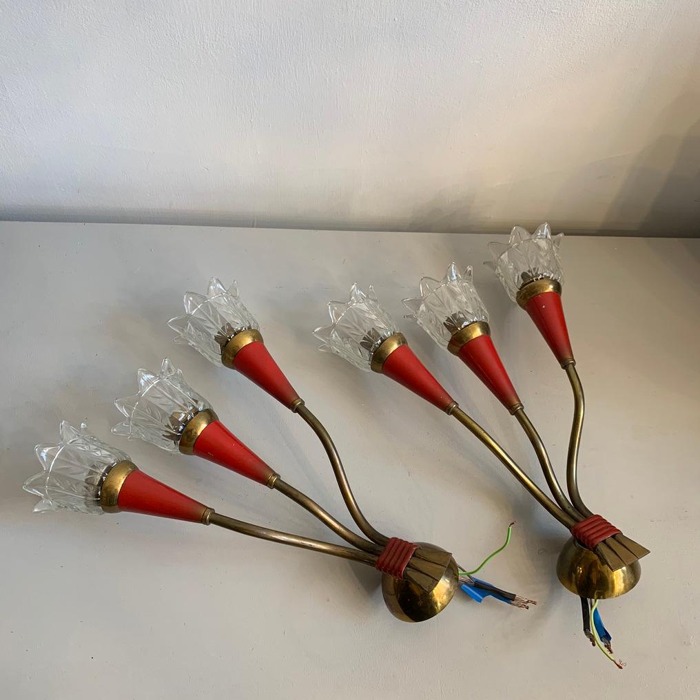 A rare pair of three branched midcentury wall lights that originate from Italy. Brass and red enamel with original glass shades in excellent condition.