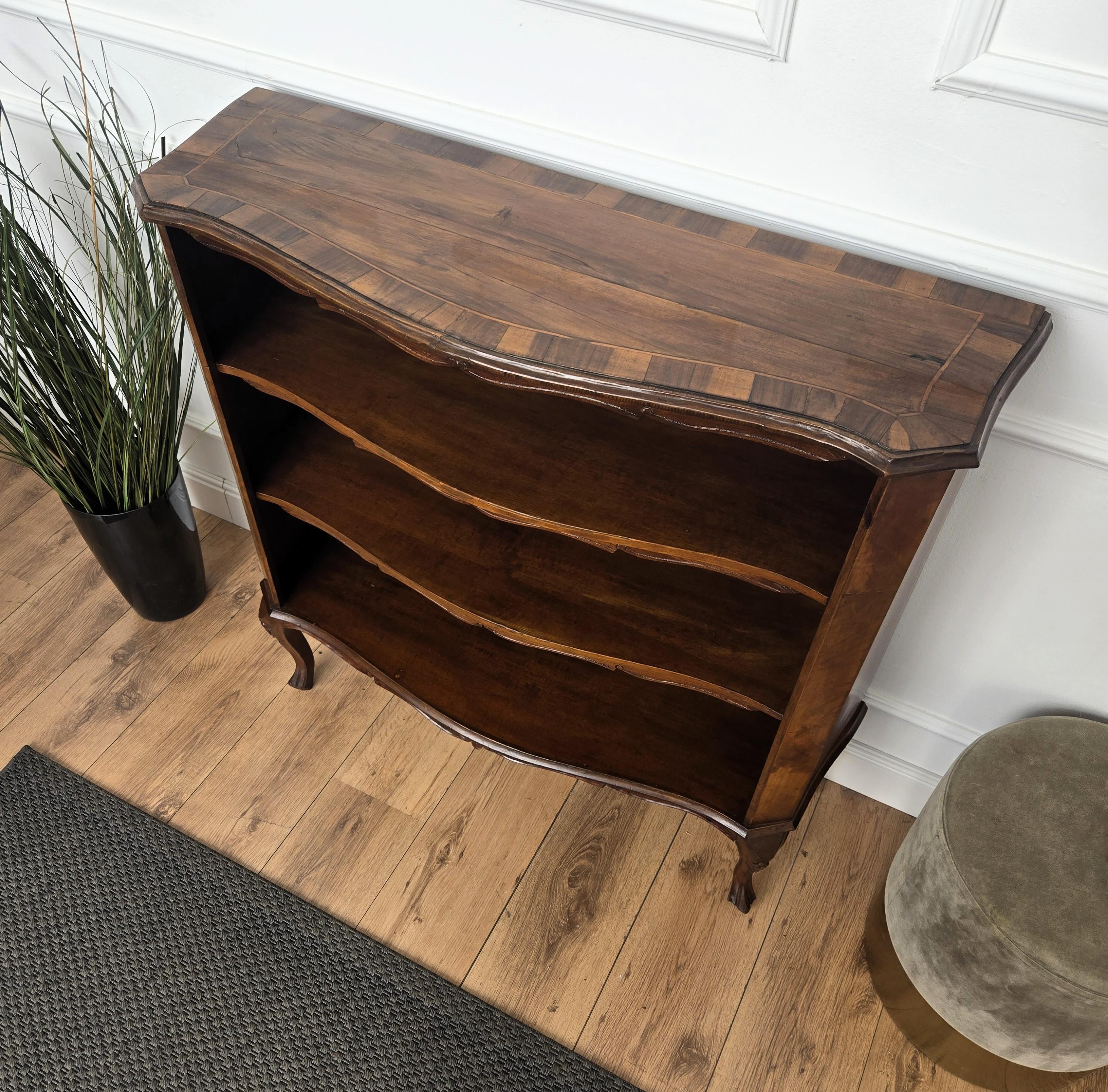 A beautiful Italian walnut, carved, three shelves, open bookcase, with great details and frames shaped in Victorian, Napoleon III, Louis XV style with beautiful burl wood pattern decors all around the piece. A very elegant, modern and classic piece