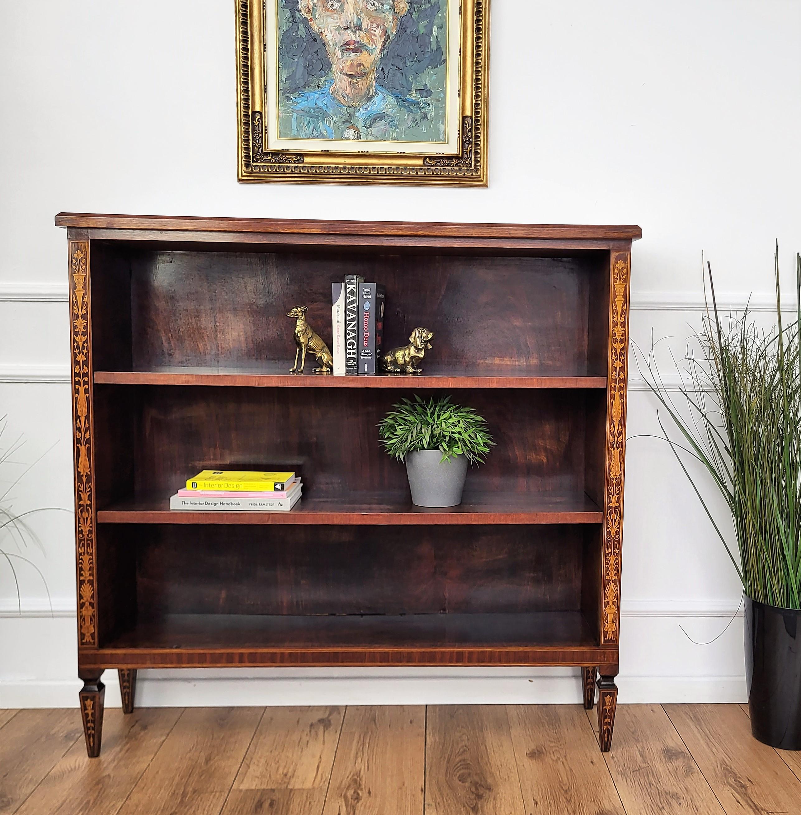 A beautiful Italian Walnut carved three shelves open bookcase, with great details and frames shaped in Victorian, Napoleon III, Louis XV style with beautiful inlay decors in classic figures all around the piece. A very elegant, modern and classic