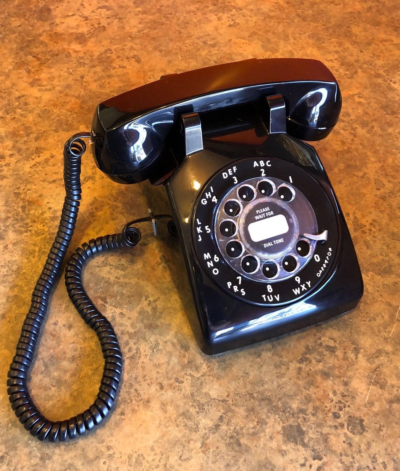 Midcentury ITT rotary dial desktop telephone with original box, circa 1970s. Phone appears to have never been used and is in very good condition with a few small blemishes.