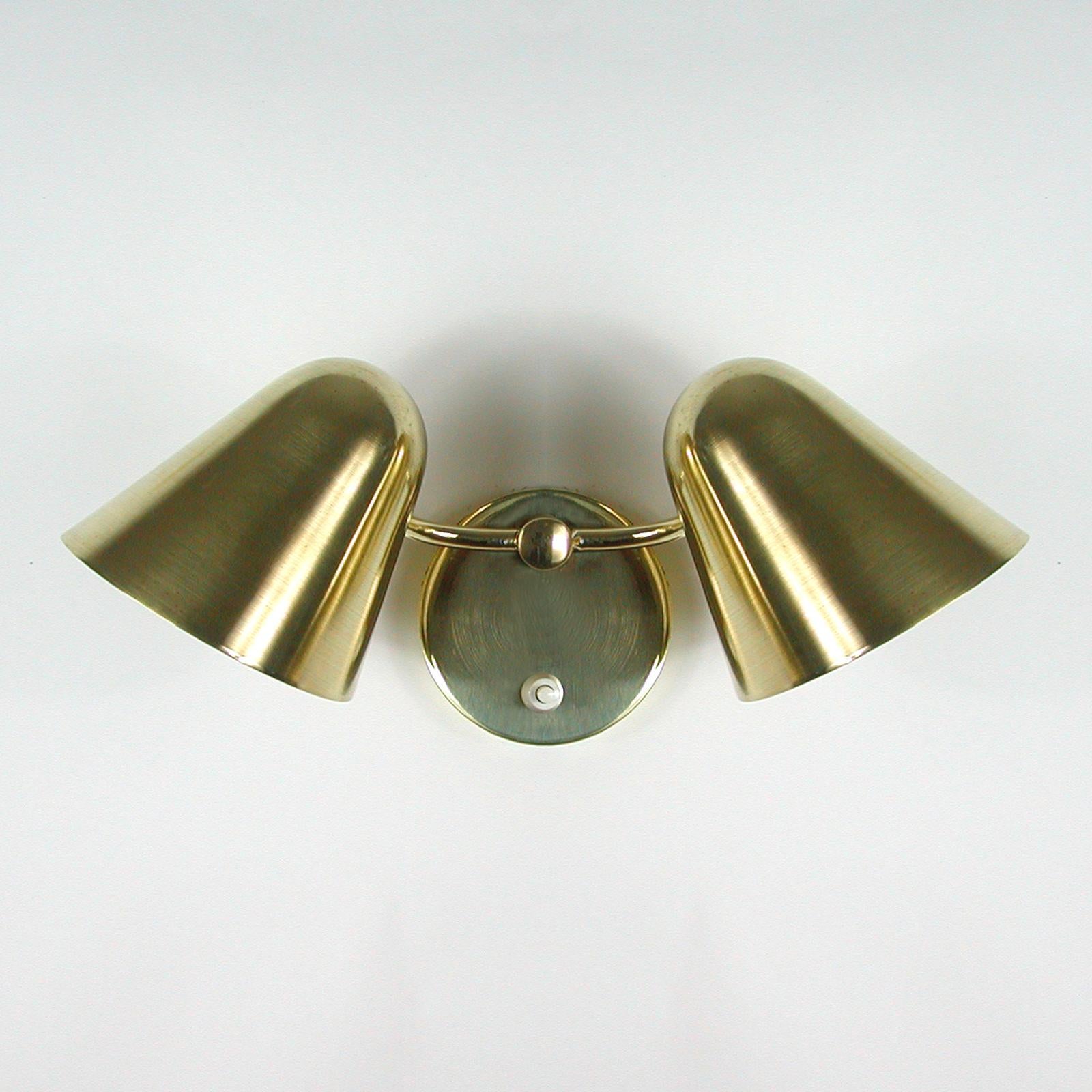 This rare double cone Cocotte wall light was designed by Jacques Biny in the 1950s. It features two adjustable brass lamp shades and a brass back plate. Both shades rotate in any direction you wish. 

Rewired for use in US and any other country of