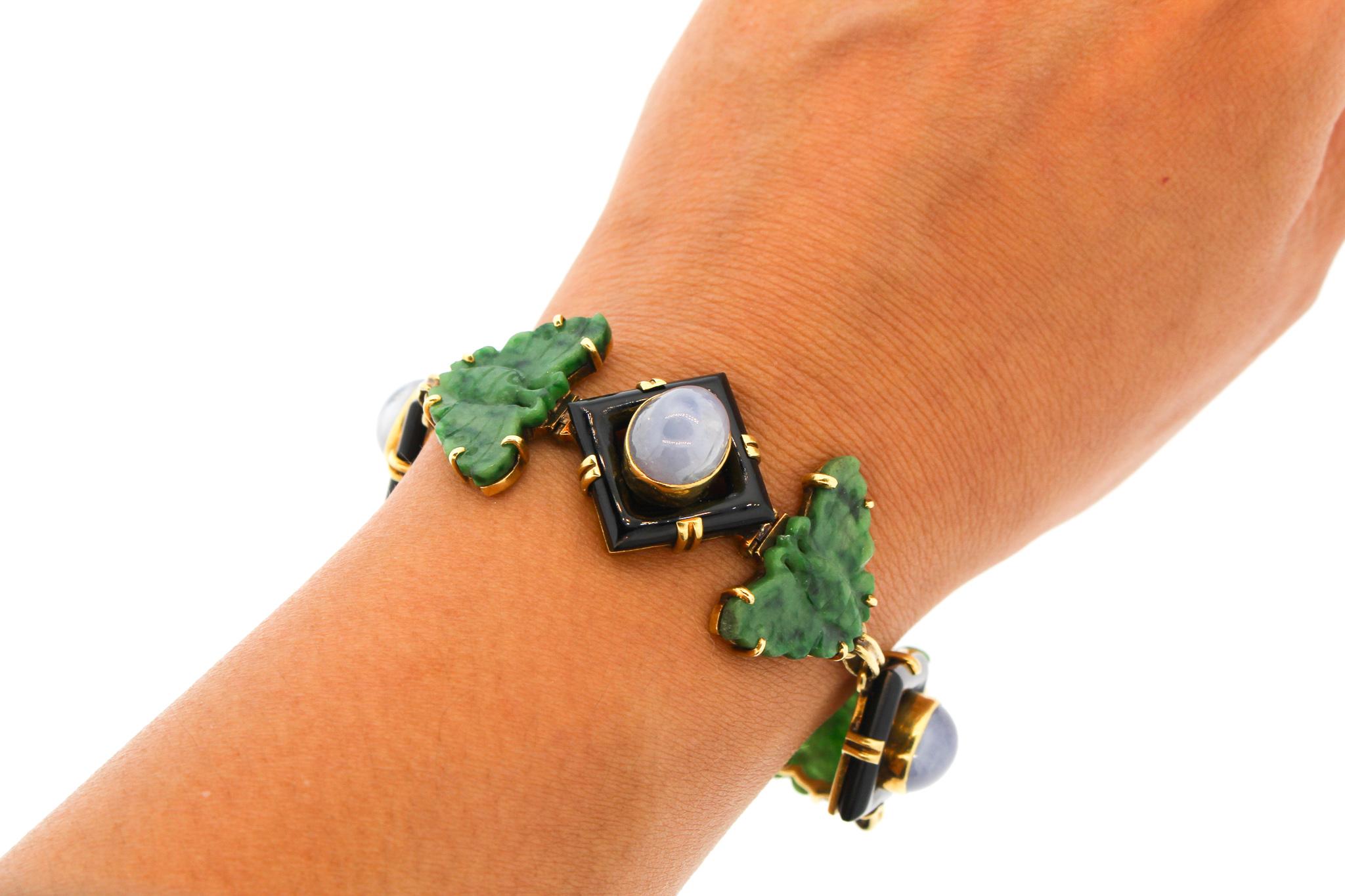 An unusual mid-century green jade butterfly bracelet made in 18k with links of carved onyx set with cabochon light blue sapphires. The bracelet was made in the 1960s and has the mark WL for Walter Lampl, who sold and made jewelry in New York. The