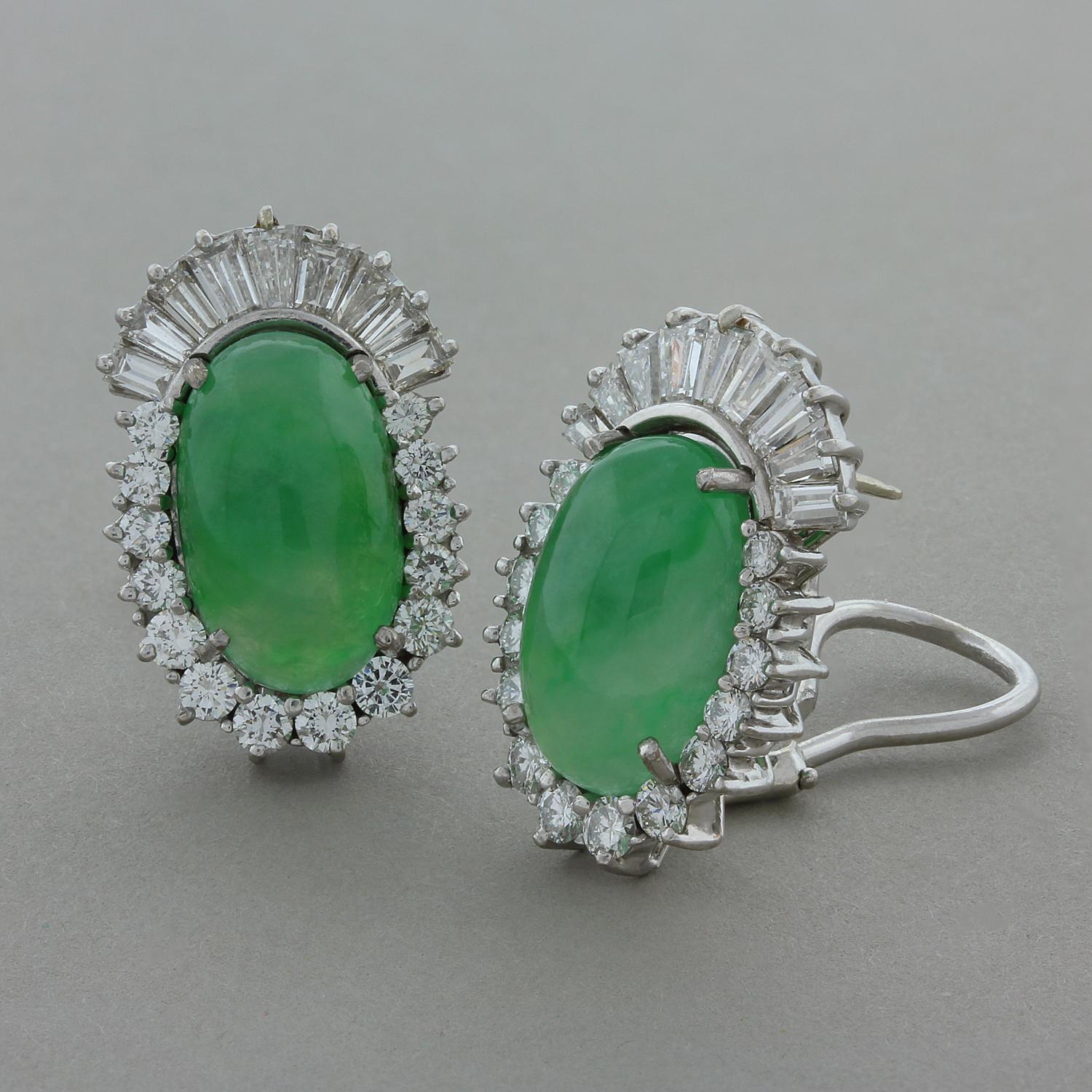 An exquisite pair of Mid-Century jewels featuring two smooth semi-translucent pieces of lustrous jade, true gems. The natural green jade is surrounded 4 carats of round and baguette cut diamonds in a 18K white gold setting with a secure omega clip