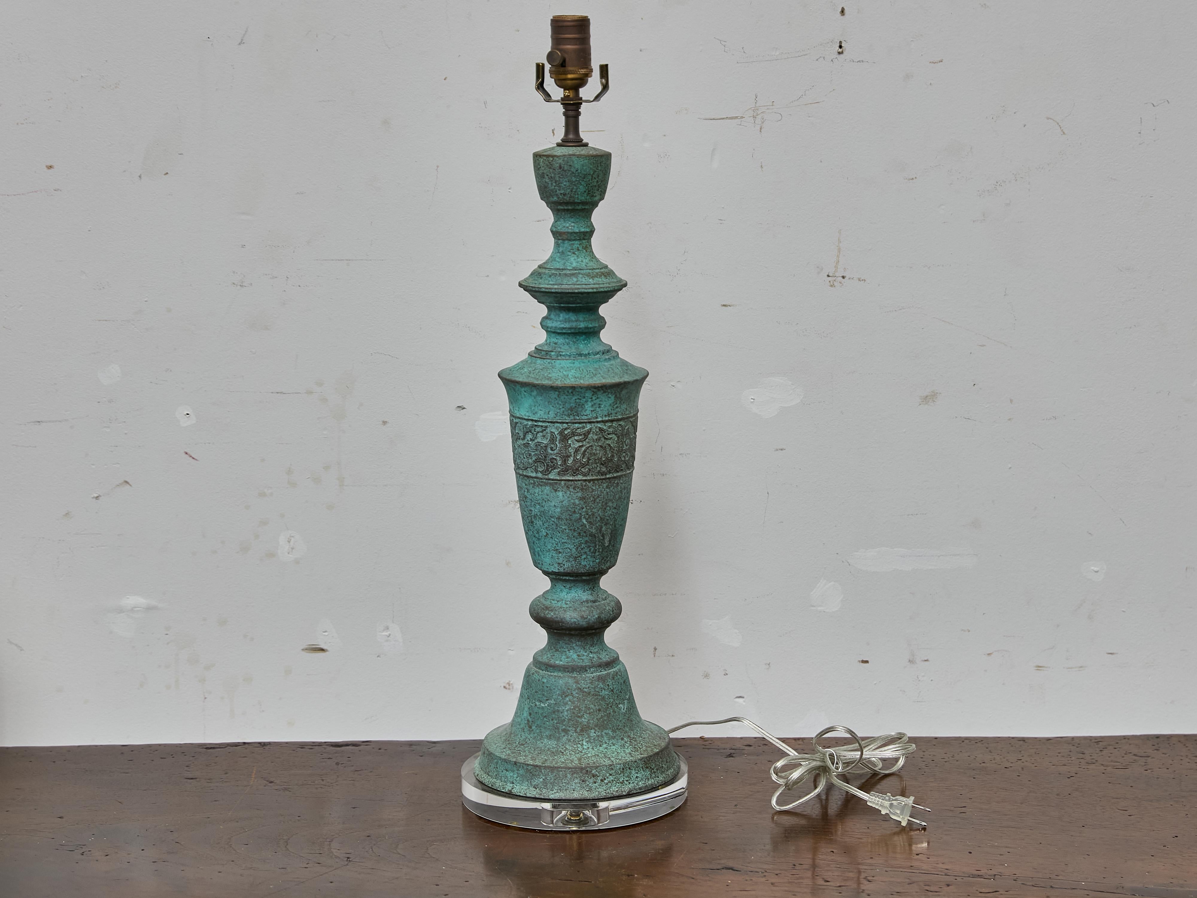 This Midcentury American table lamp channels the bold aesthetic of James Mont, known for blending Eastern and Western influences into sculptural, statement-making forms. Cast in bronze and finished in a richly mottled verdigris patina, the lamp