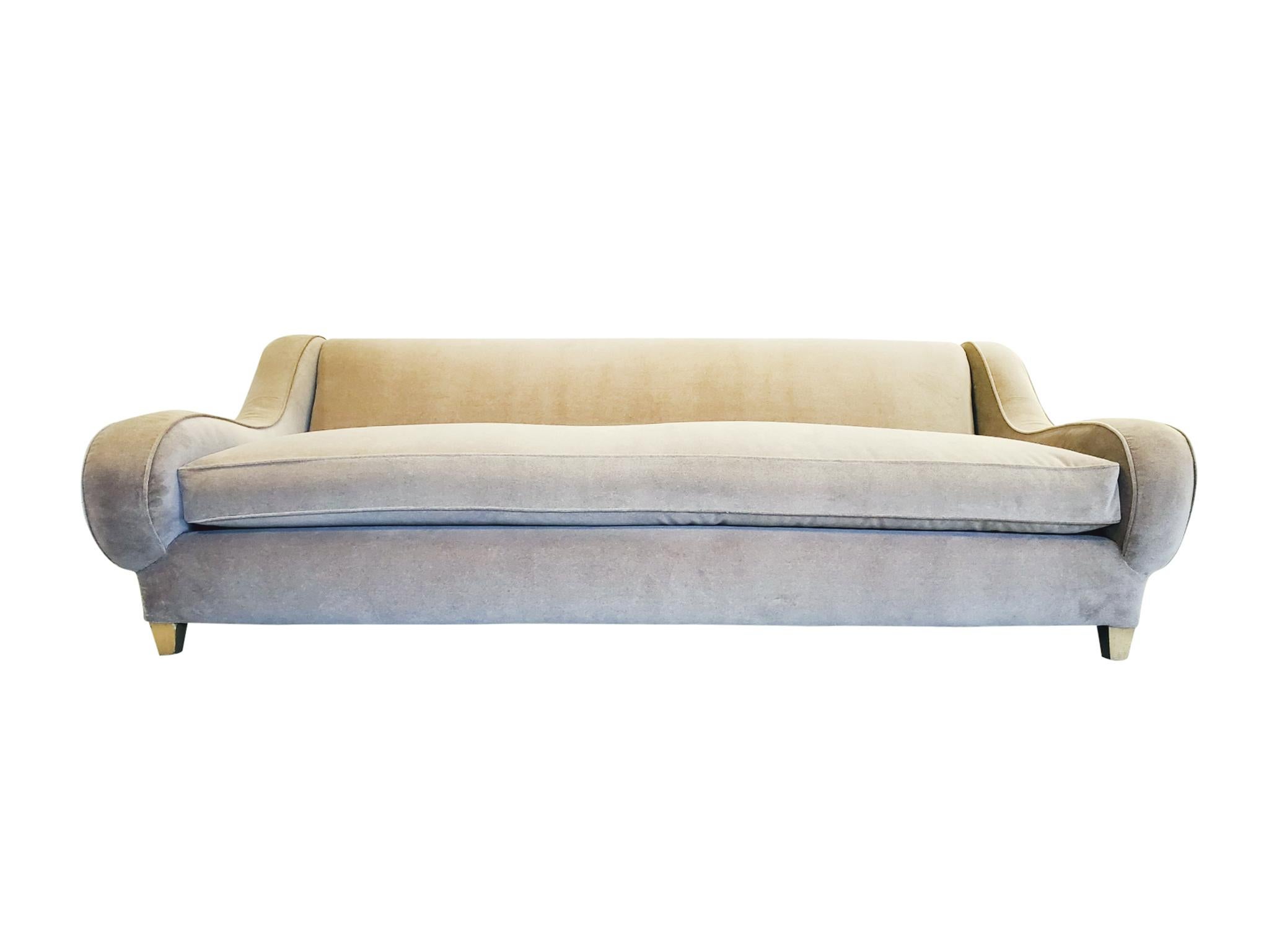 Mid-20th century sofa designed by James Mont. It is newly reupholstered in a taupe-toned velvet mohair. The elegant design is one of smooth lines and curves. We particularly love the flair of the sloping arms! A beautifully chic sofa for any