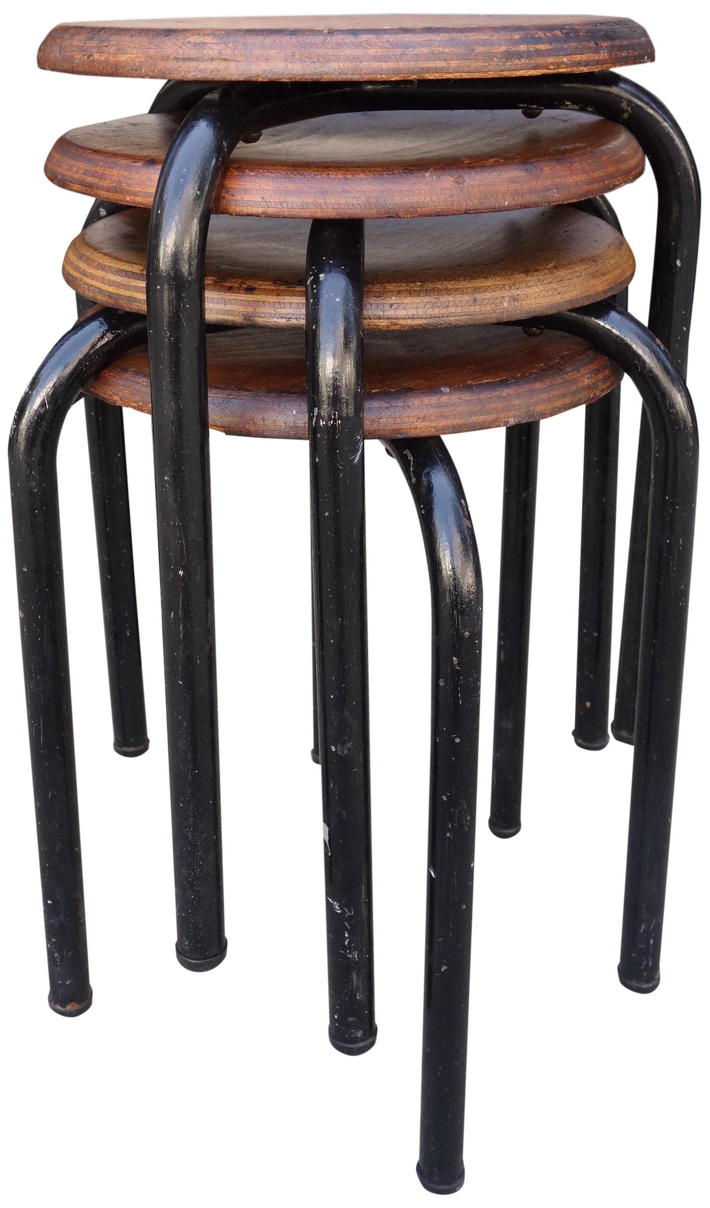 Atelier Jean Prouvé designed for the Lycée Fabert, Metz. France, 1930s. Lacquered metal base and turned plywood seat. All have markings on the underside. These wonderful stools also make great side tables or end tables. 

Measures: Seat is 13''