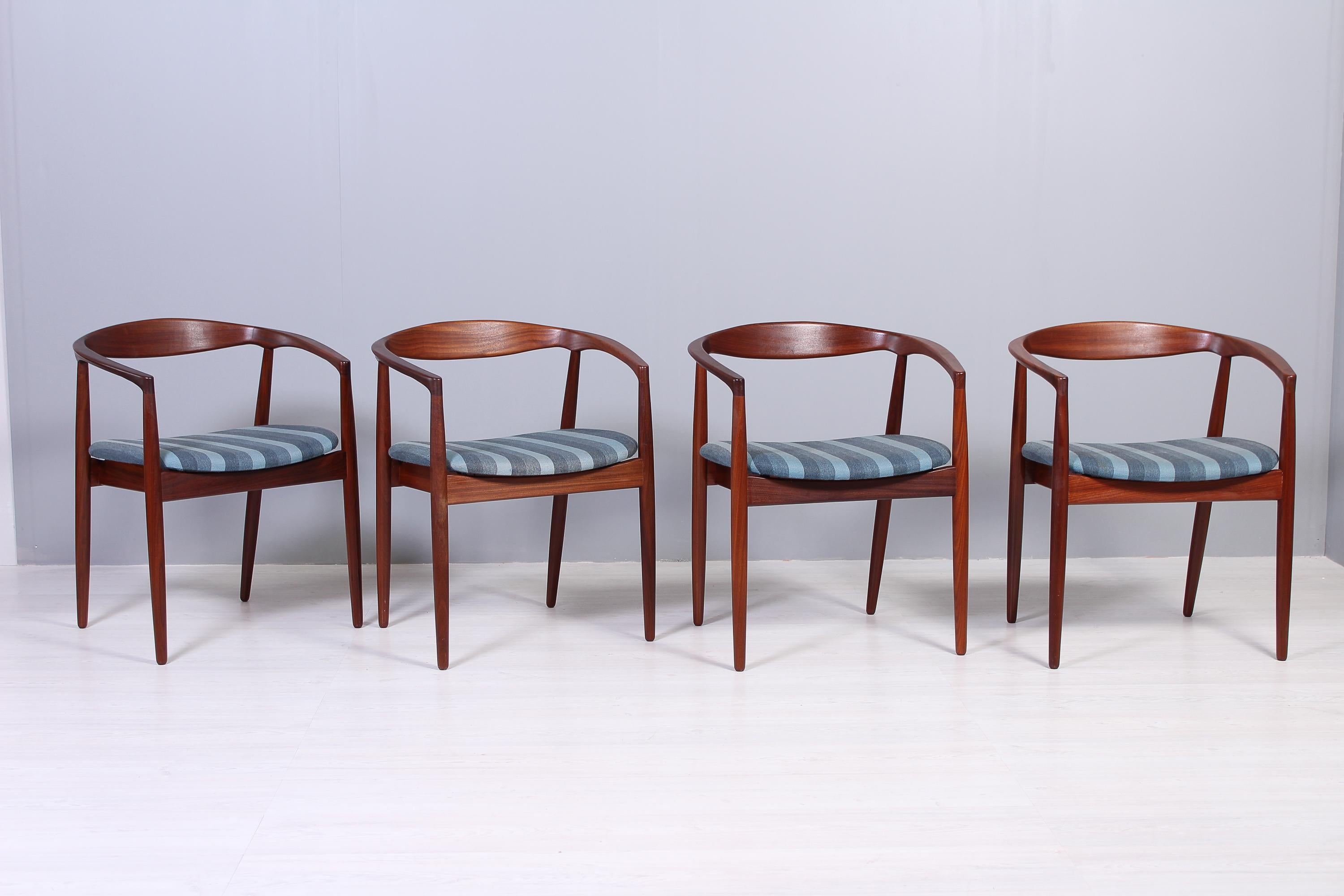A set of four Kai Kristiansen teak chairs of the model Troja. The chairs have their original wool upholstery. Very good vintage condition on frames with only small signs of usage. Fabric with small signs of usage and wear consistent with age. We can