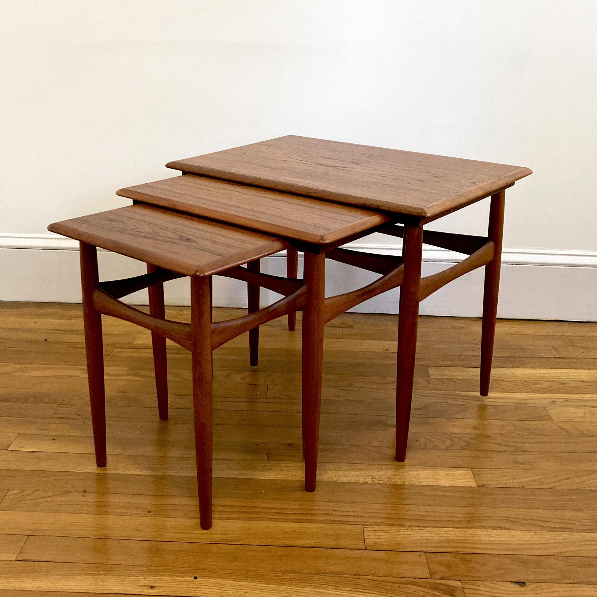 Circa 1960s, set of (3) Danish mid-century nesting tables designed by Kai Kristiansen for Skovmand & Andersen. Smallest table is marked underneath: 